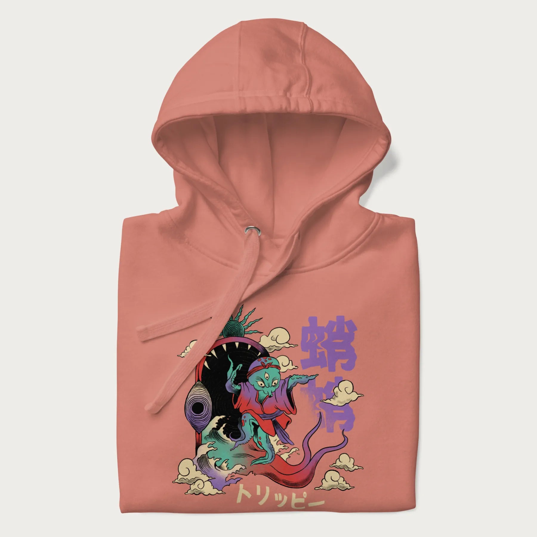 Folded light pink hoodie with Japanese graphic of a colorful psychedelic octopus, with Japanese text '蛸' (Octopus) and 'トリッピー' (Trippy).