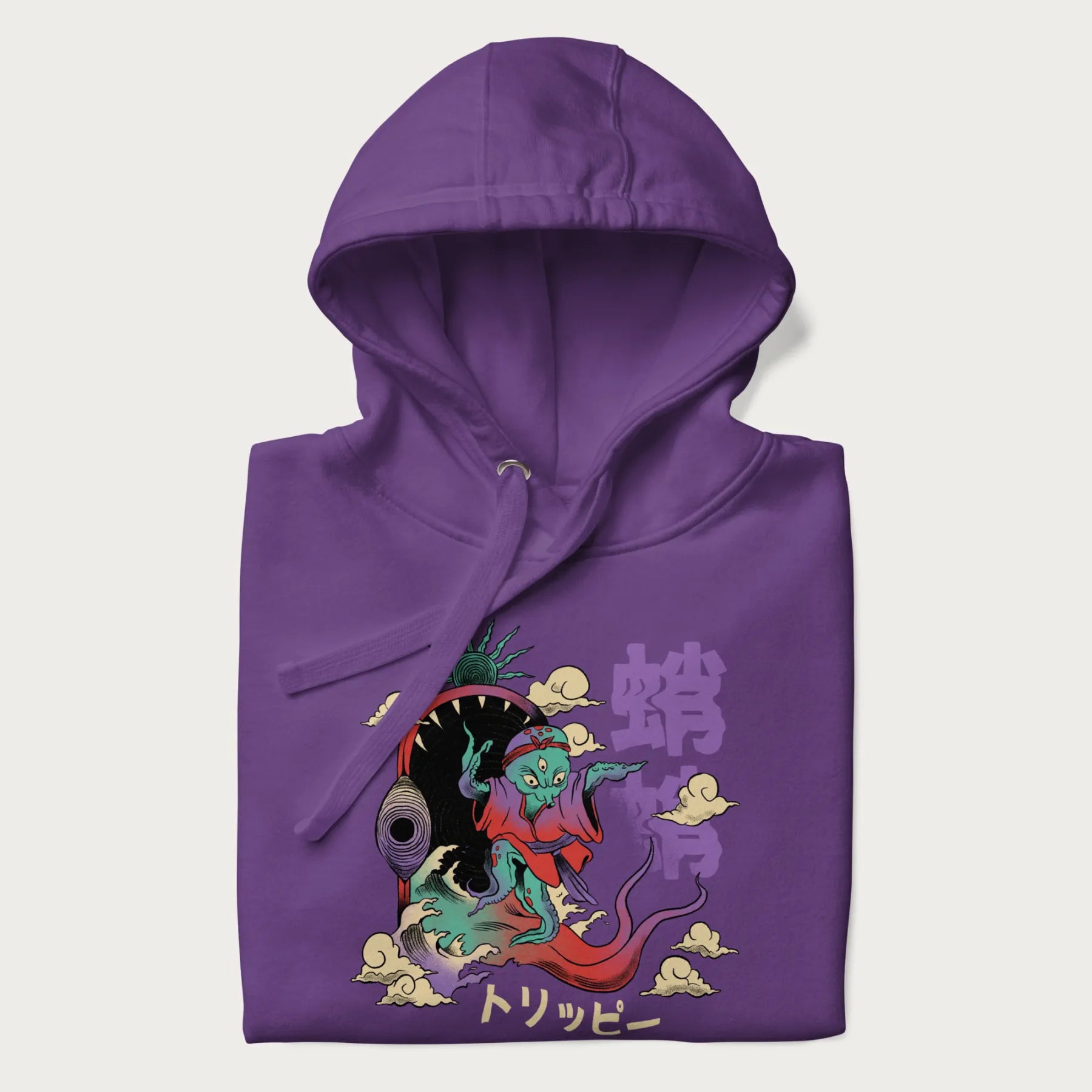 Folded purple hoodie with Japanese graphic of a colorful psychedelic octopus, with Japanese text '蛸' (Octopus) and 'トリッピー' (Trippy).