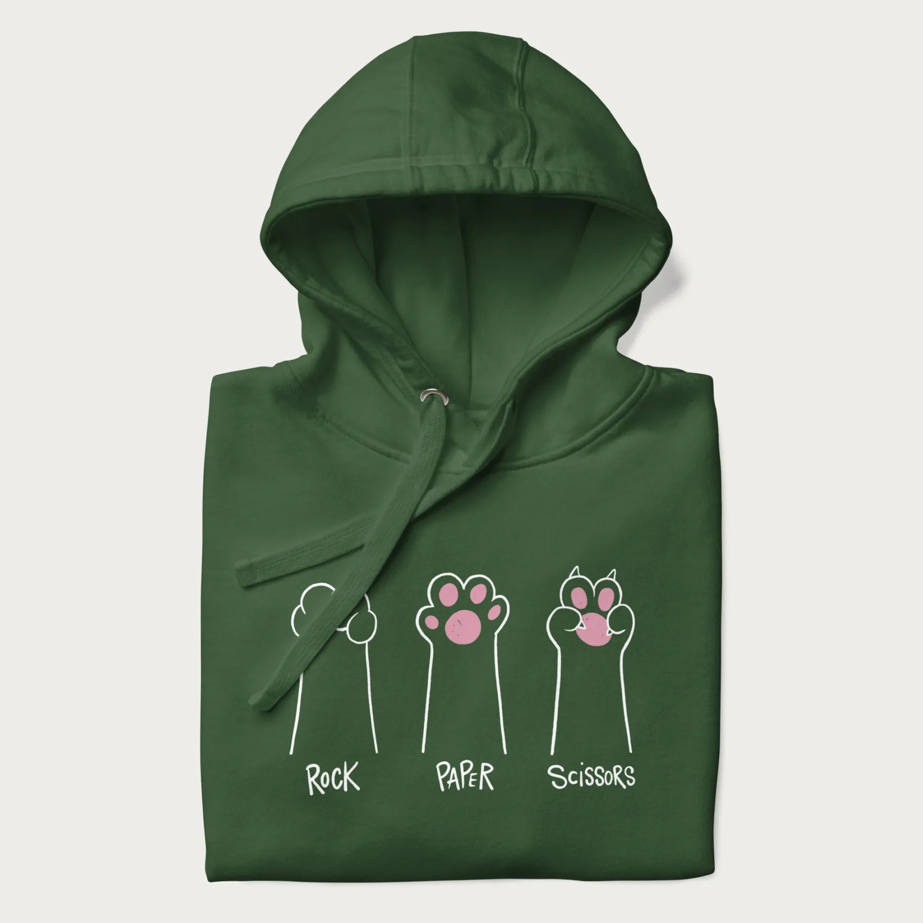 Folded forest green hoodie with graphic of cat paws playing rock-paper-scissors.