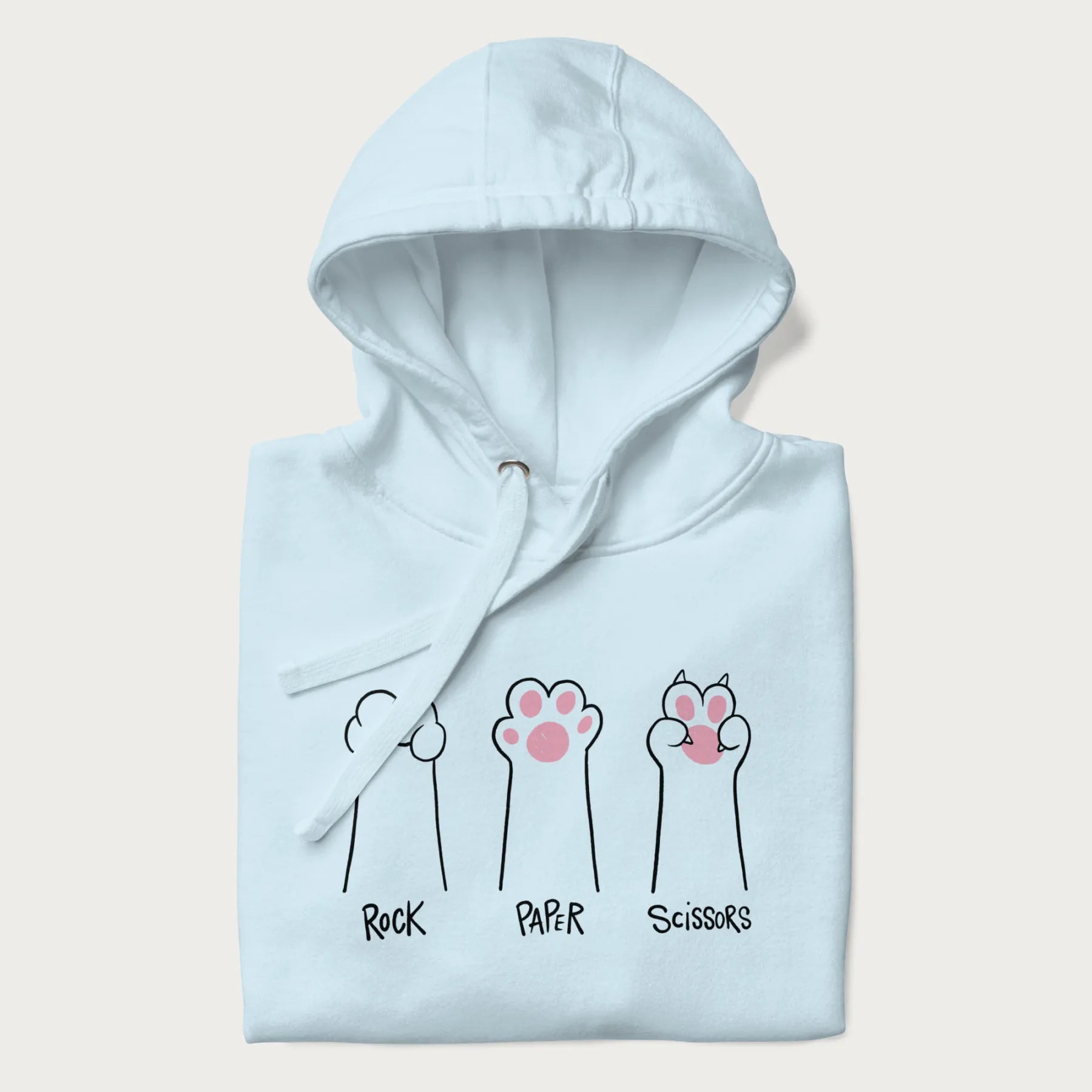 Folded light blue hoodie with graphic of cat paws playing rock-paper-scissors.