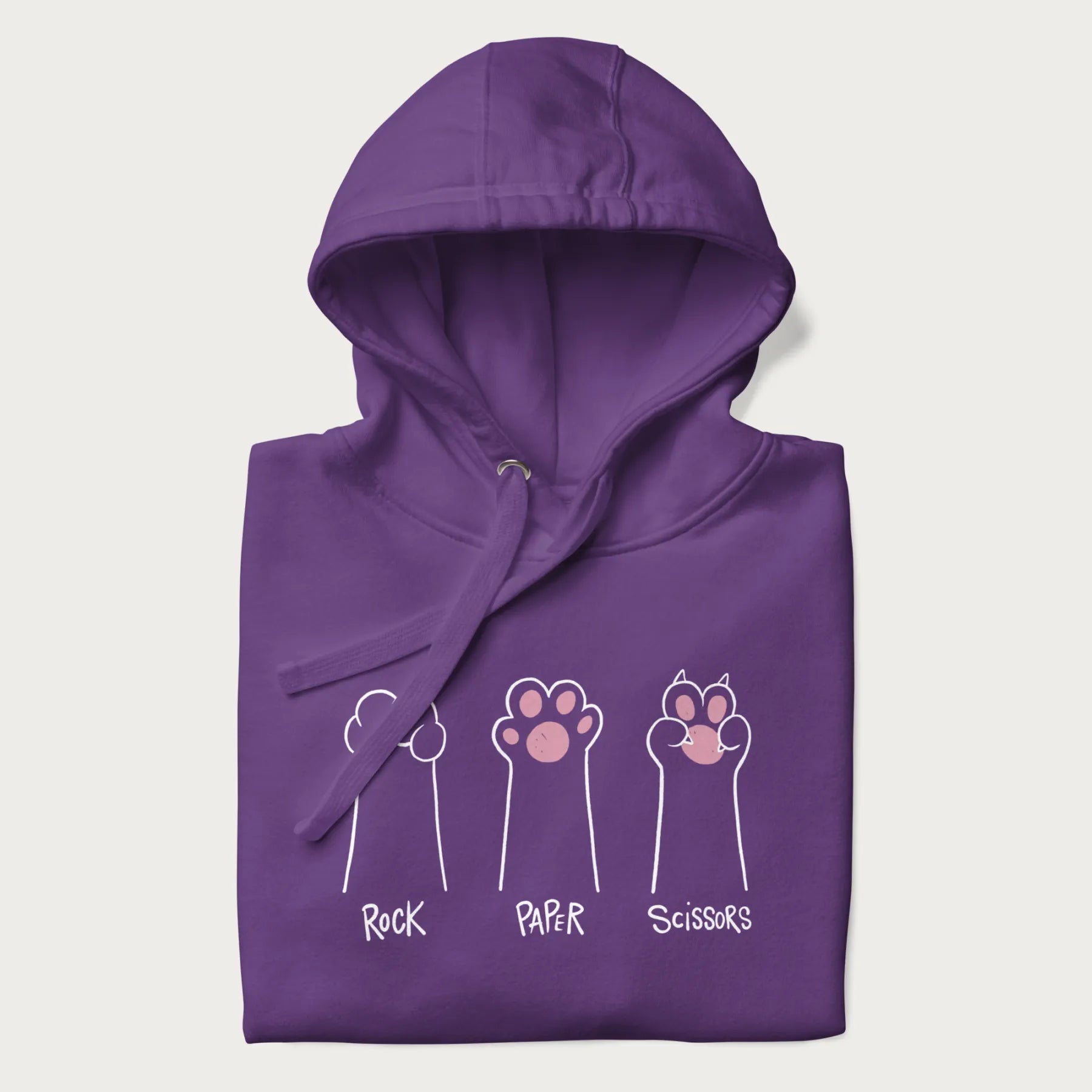 Folded purple hoodie with graphic of cat paws playing rock-paper-scissors.