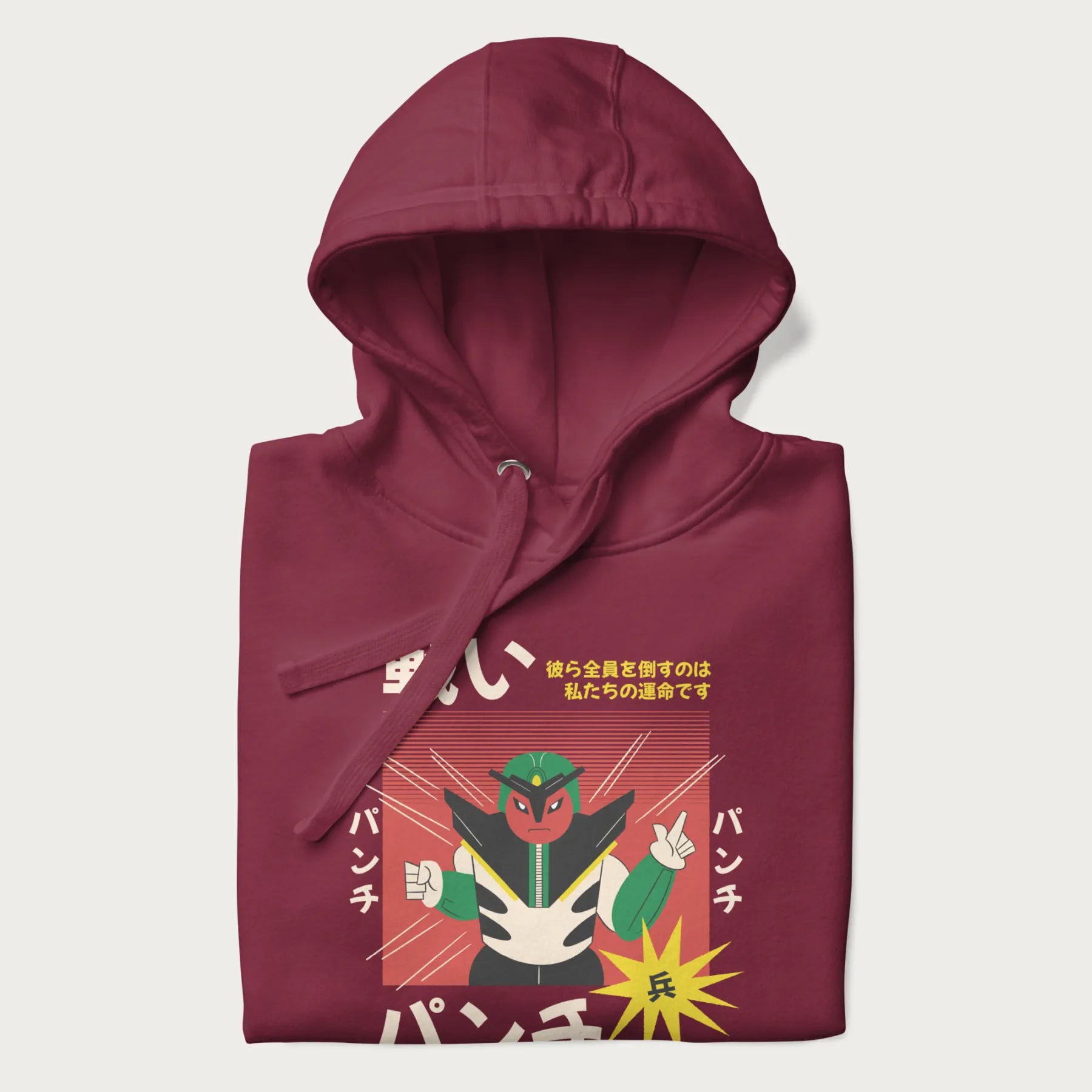 Folded maroon hoodie with Japanese retro graphic of a samurai-inspired robot and Japanese words for "Fight," "Punch," and "Soldier".