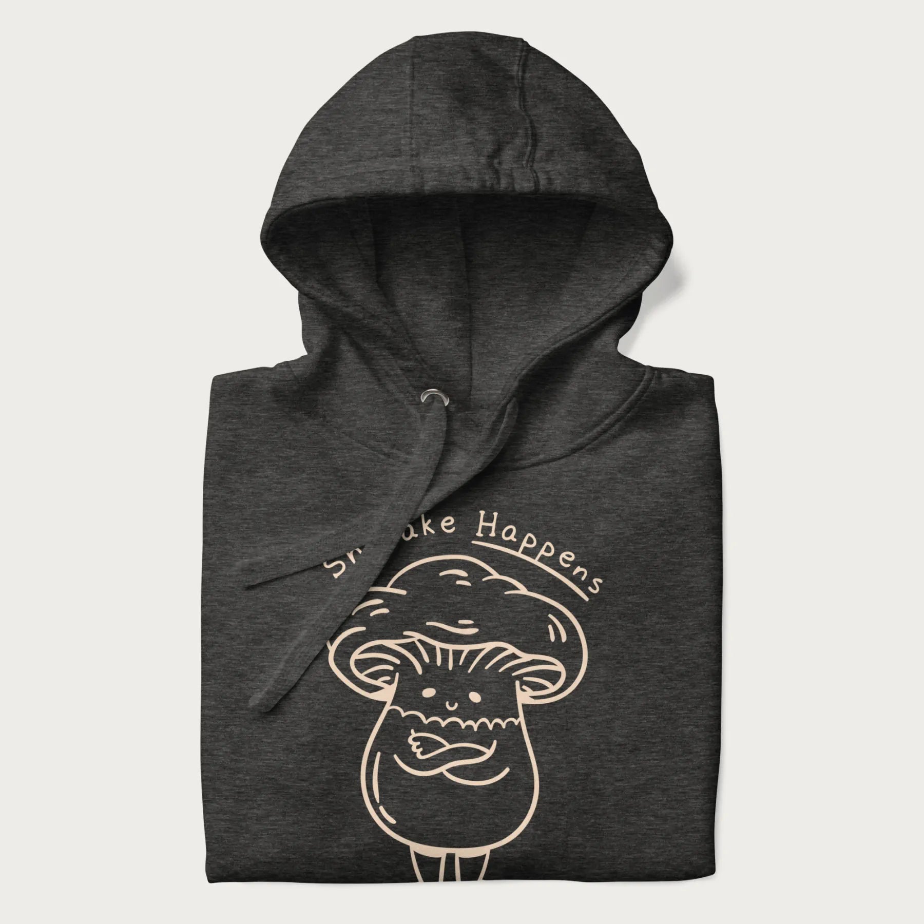 Folded dark grey hoodie featuring a cute shiitake mushroom graphic with the text "Shiitake Happens."