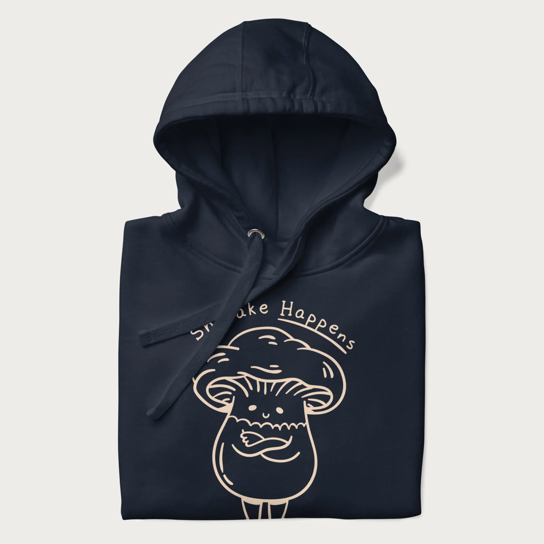 Folded navy blue hoodie featuring a cute shiitake mushroom graphic with the text "Shiitake Happens."