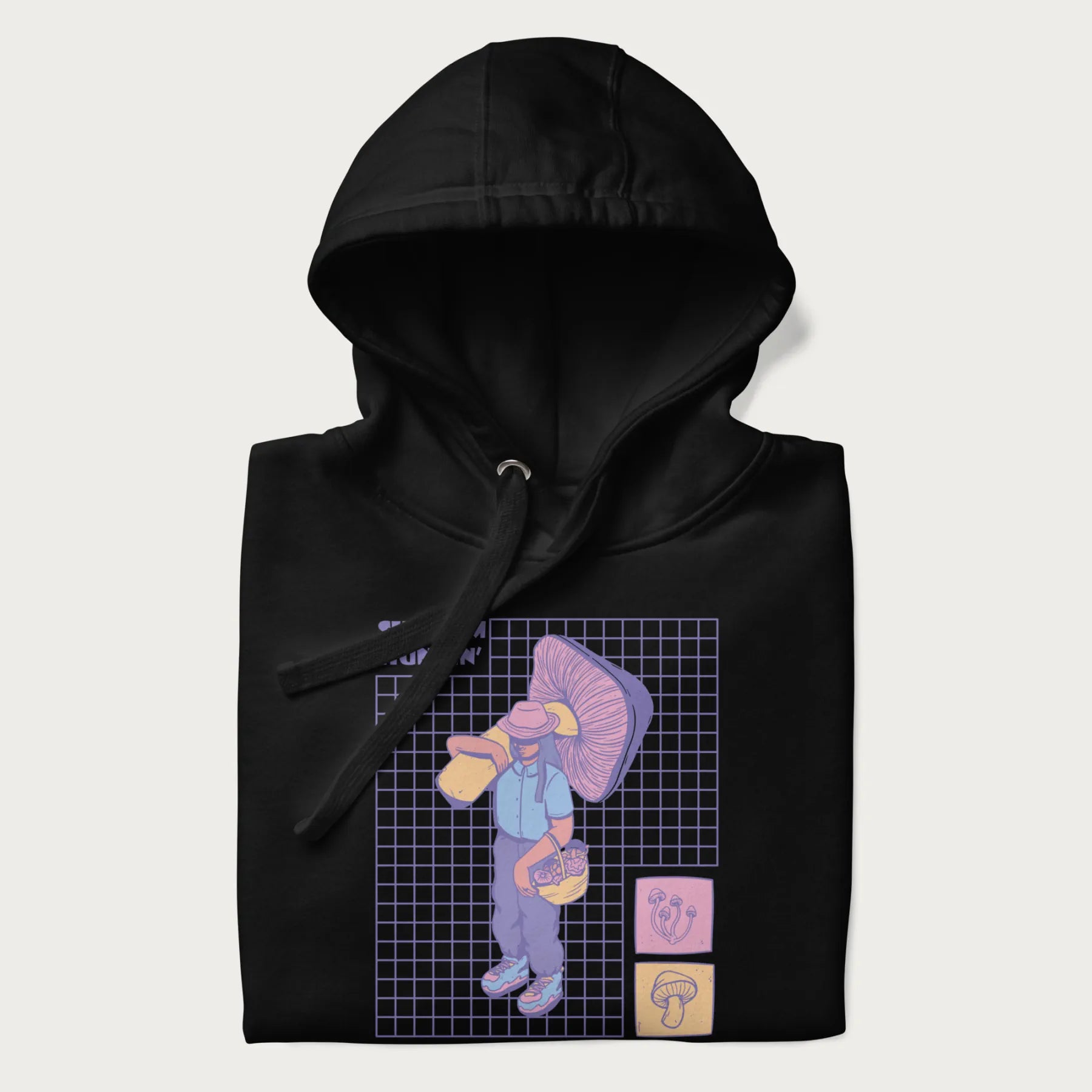 Folded black hoodie featuring a graphic of a girl carrying a large mushroom and a basket of fungi, with the text "Shroom Huntin'".