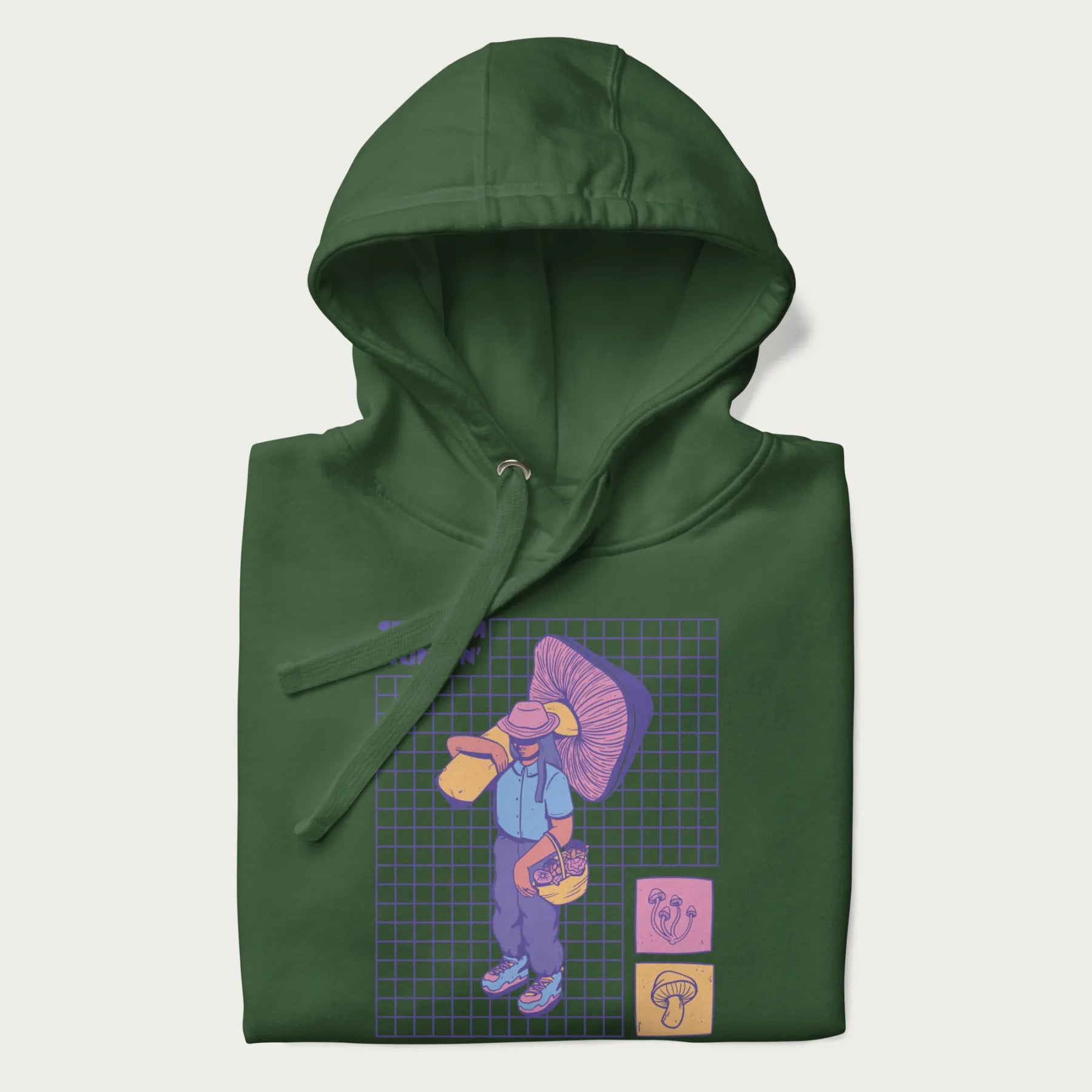 Folded forest green hoodie featuring a graphic of a girl carrying a large mushroom and a basket of fungi, with the text "Shroom Huntin'".