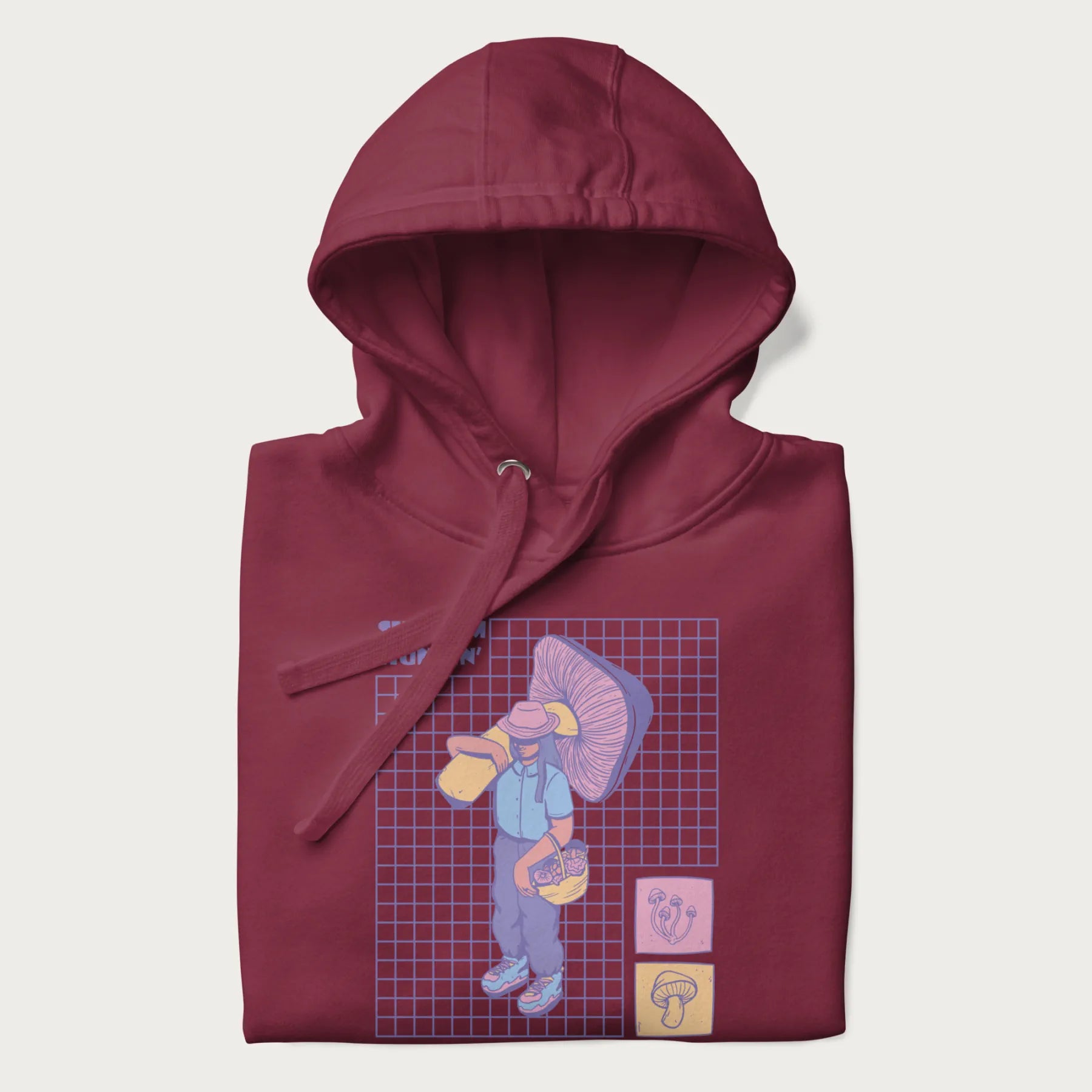 Folded maroon hoodie featuring a graphic of a girl carrying a large mushroom and a basket of fungi, with the text "Shroom Huntin'".