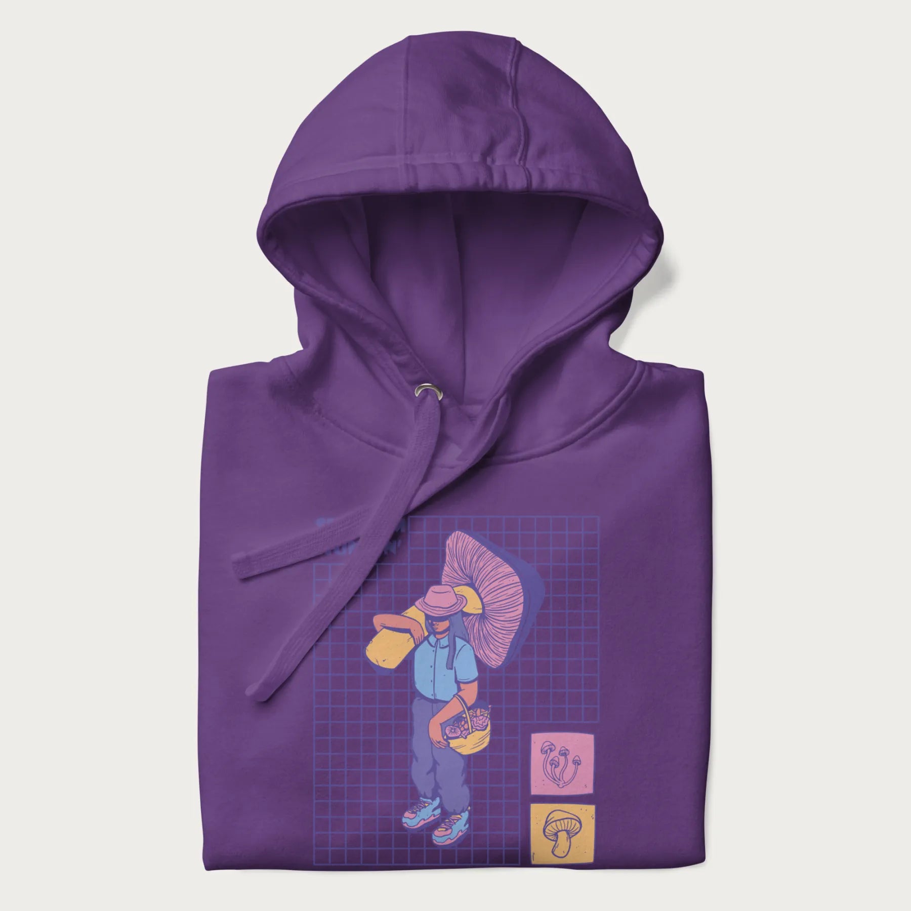 Folded purple hoodie featuring a graphic of a girl carrying a large mushroom and a basket of fungi, with the text "Shroom Huntin'".