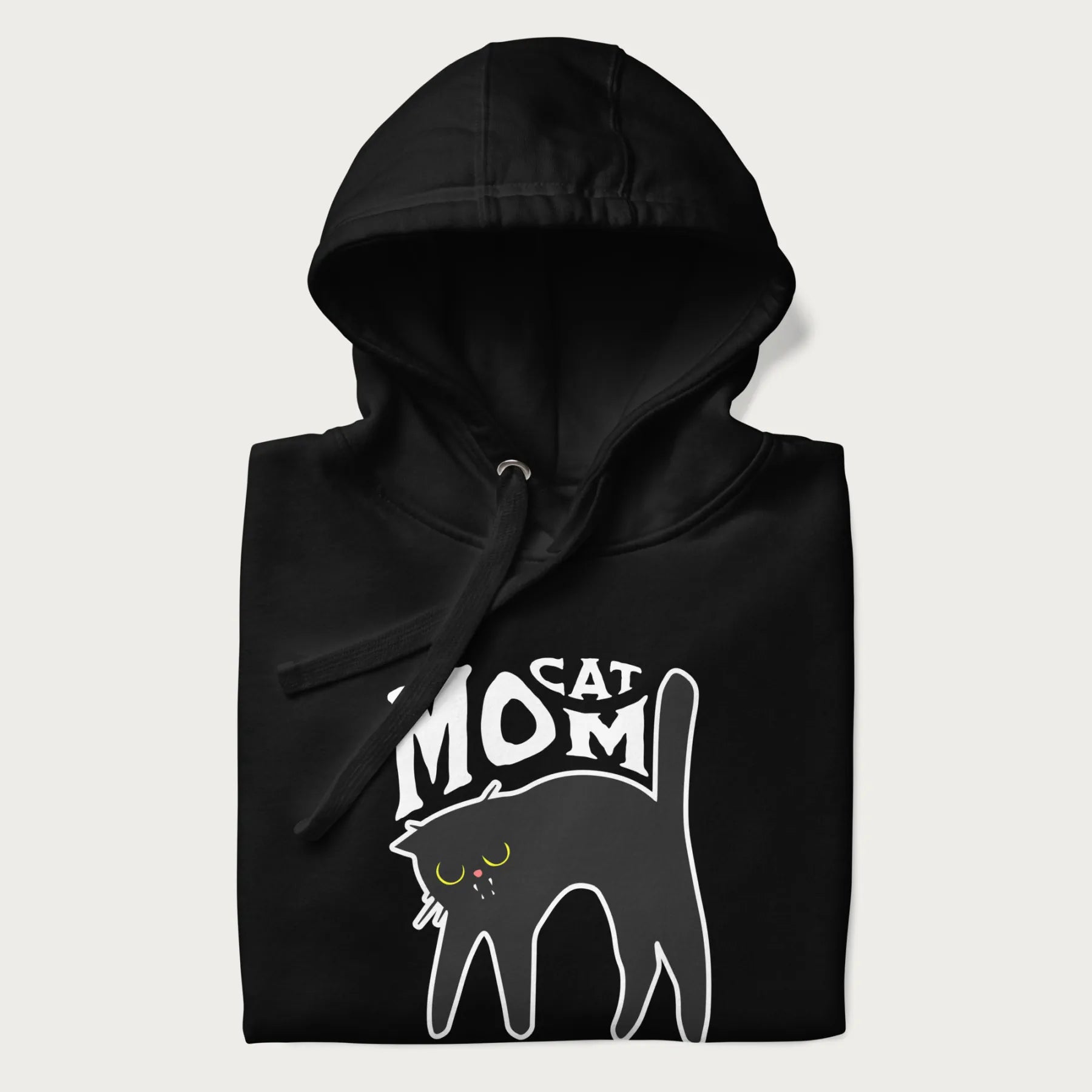 Folded black hoodie with 'Cat Mom' in white lettering above a minimalistic graphic of a black cat with yellow eyes.