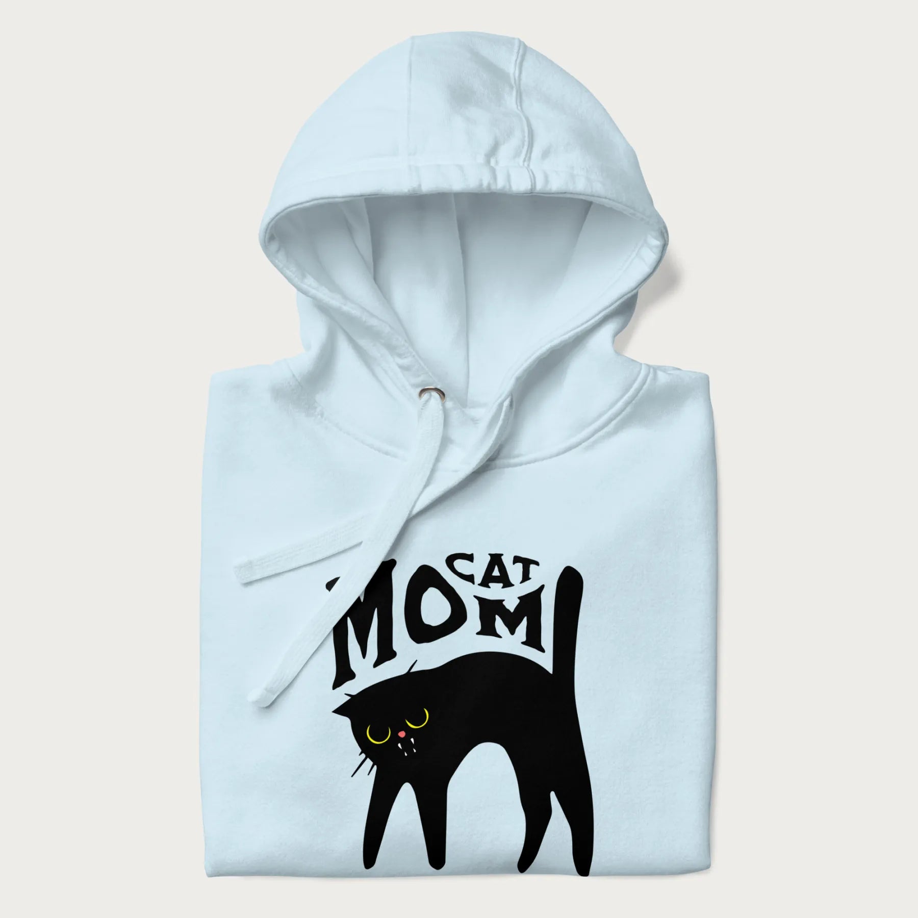 Folded light blue hoodie with 'Cat Mom' in black lettering above a minimalistic graphic of a black cat with yellow eyes.