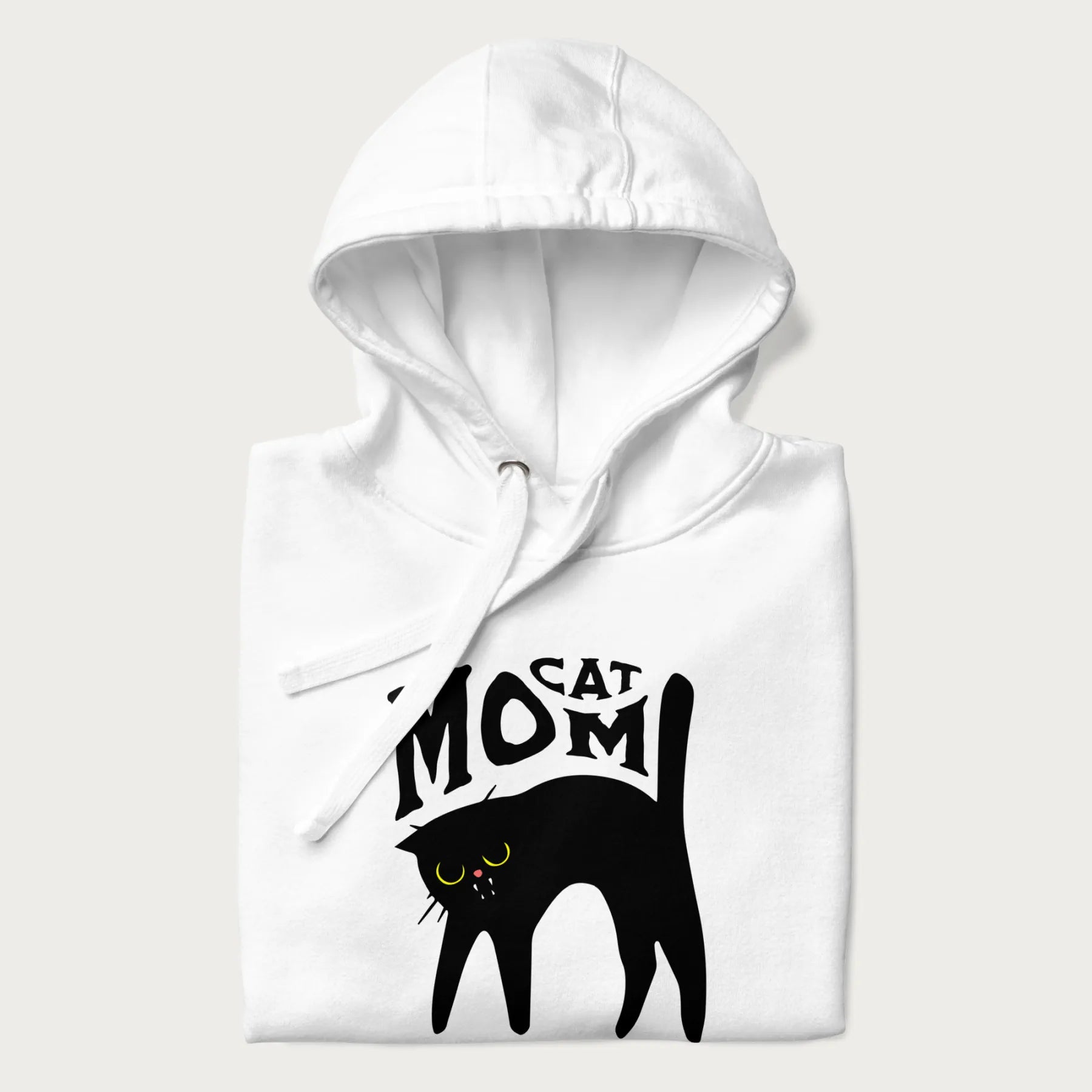 Folded white hoodie with 'Cat Mom' in black lettering above a minimalistic graphic of a black cat with yellow eyes.