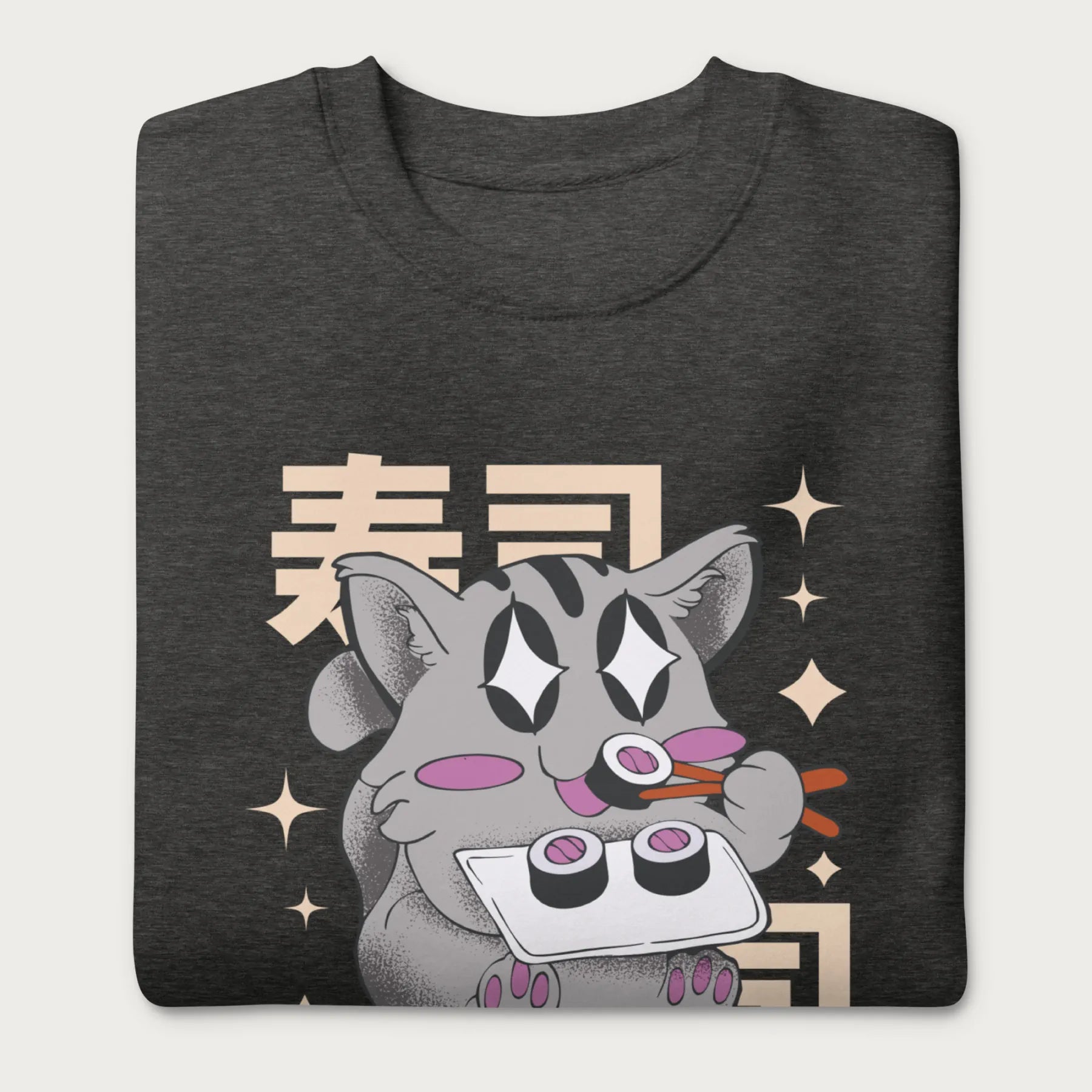 Folded dark grey sweatshirt with Japanese text and a kawaii graphic of a cat eating sushi.