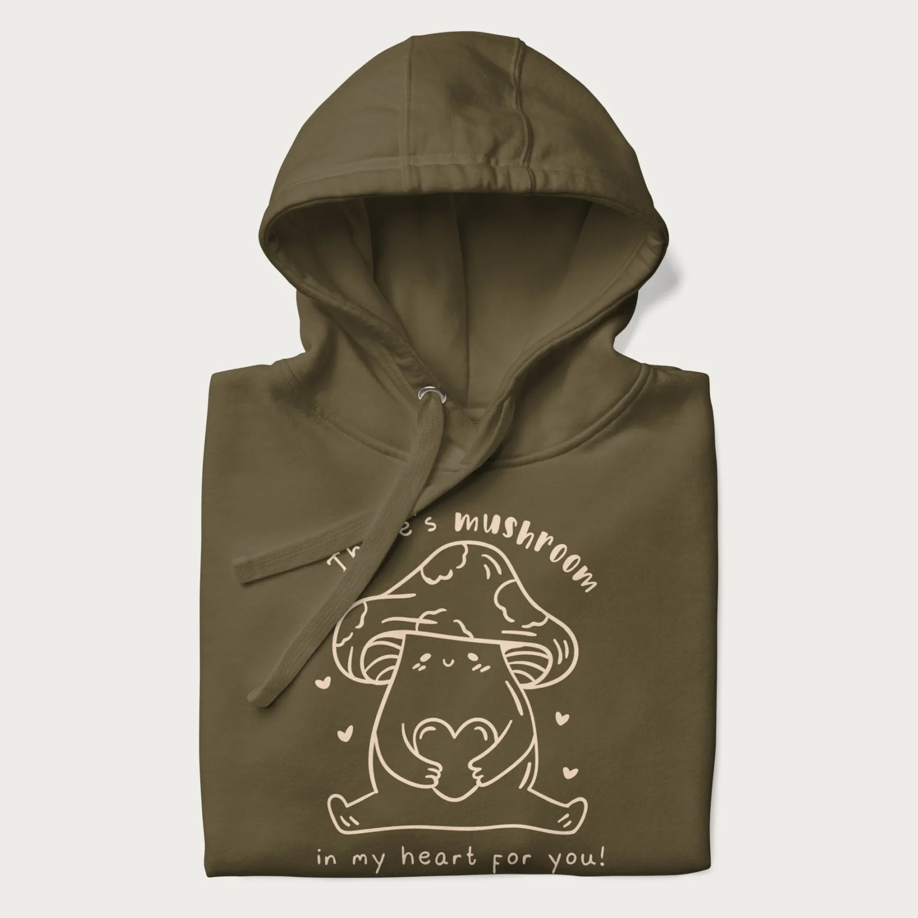 Folded military green hoodie with graphic of a cute mushroom holding a heart with the text "There's Mushroom in My Heart for You!"