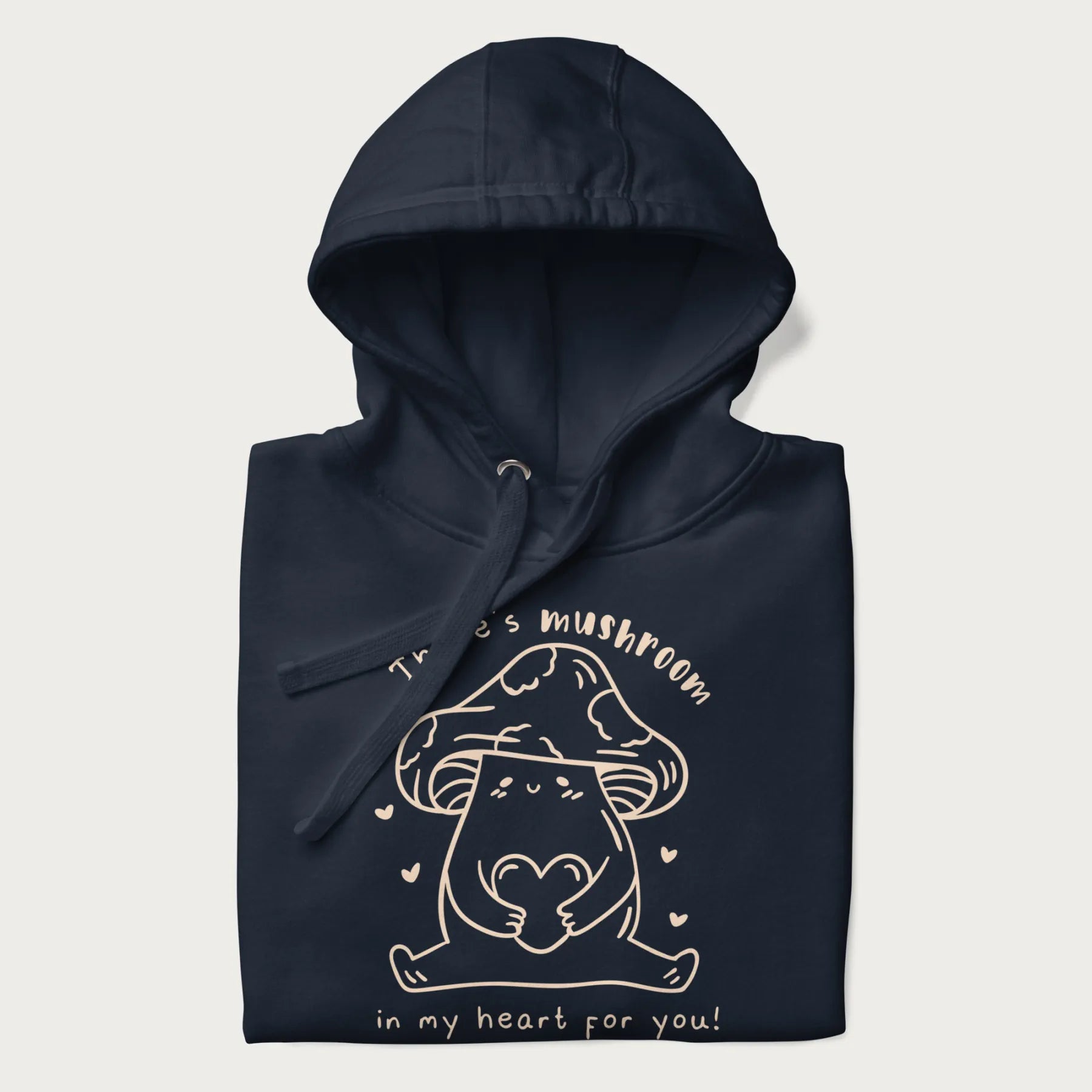 Folded navy blue hoodie with graphic of a cute mushroom holding a heart with the text "There's Mushroom in My Heart for You!"