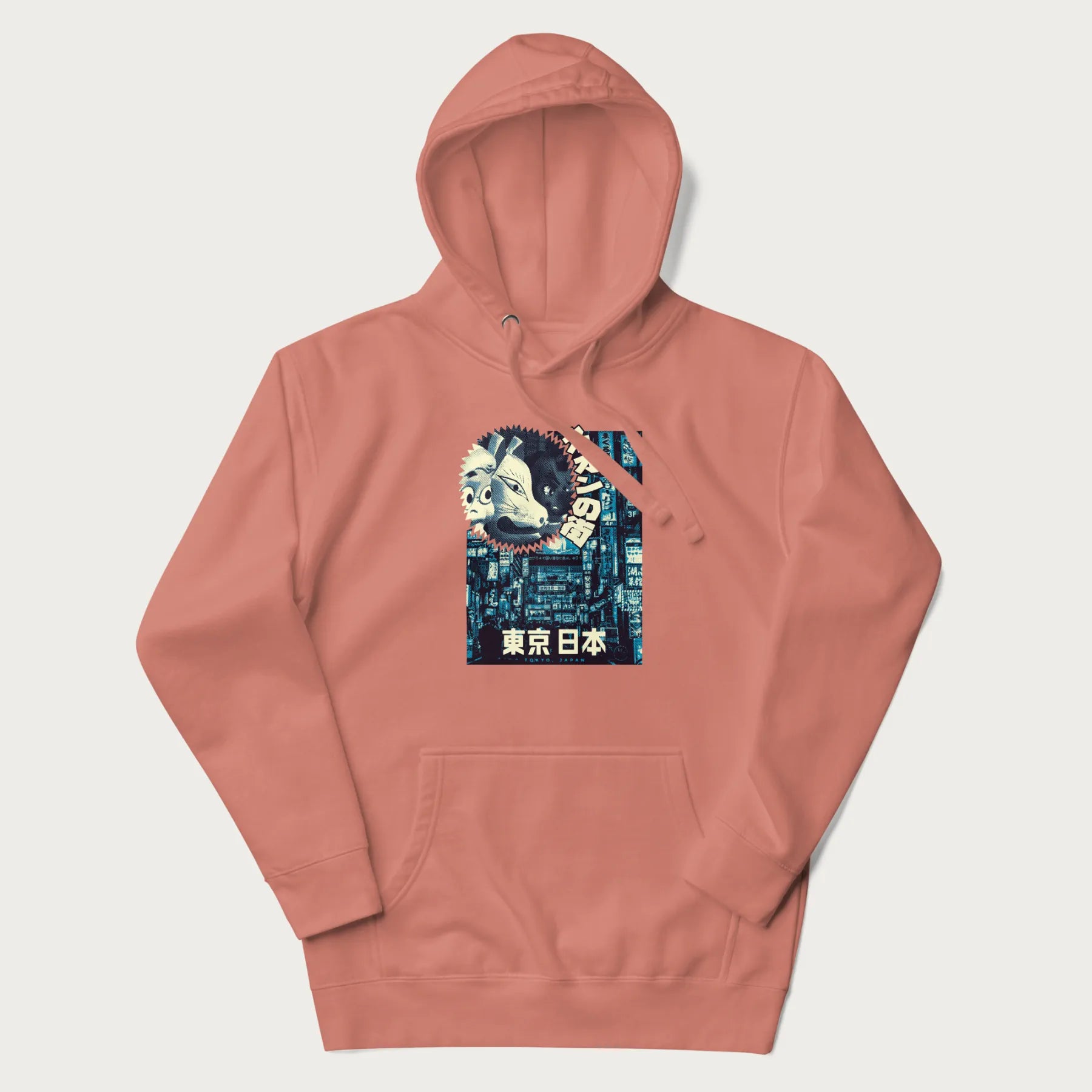 Light pink hoodie with Japanese text '東京日本' translating to 'Tokyo, Japan', with three traditional Japanese masks over a neon-lit Tokyo background.