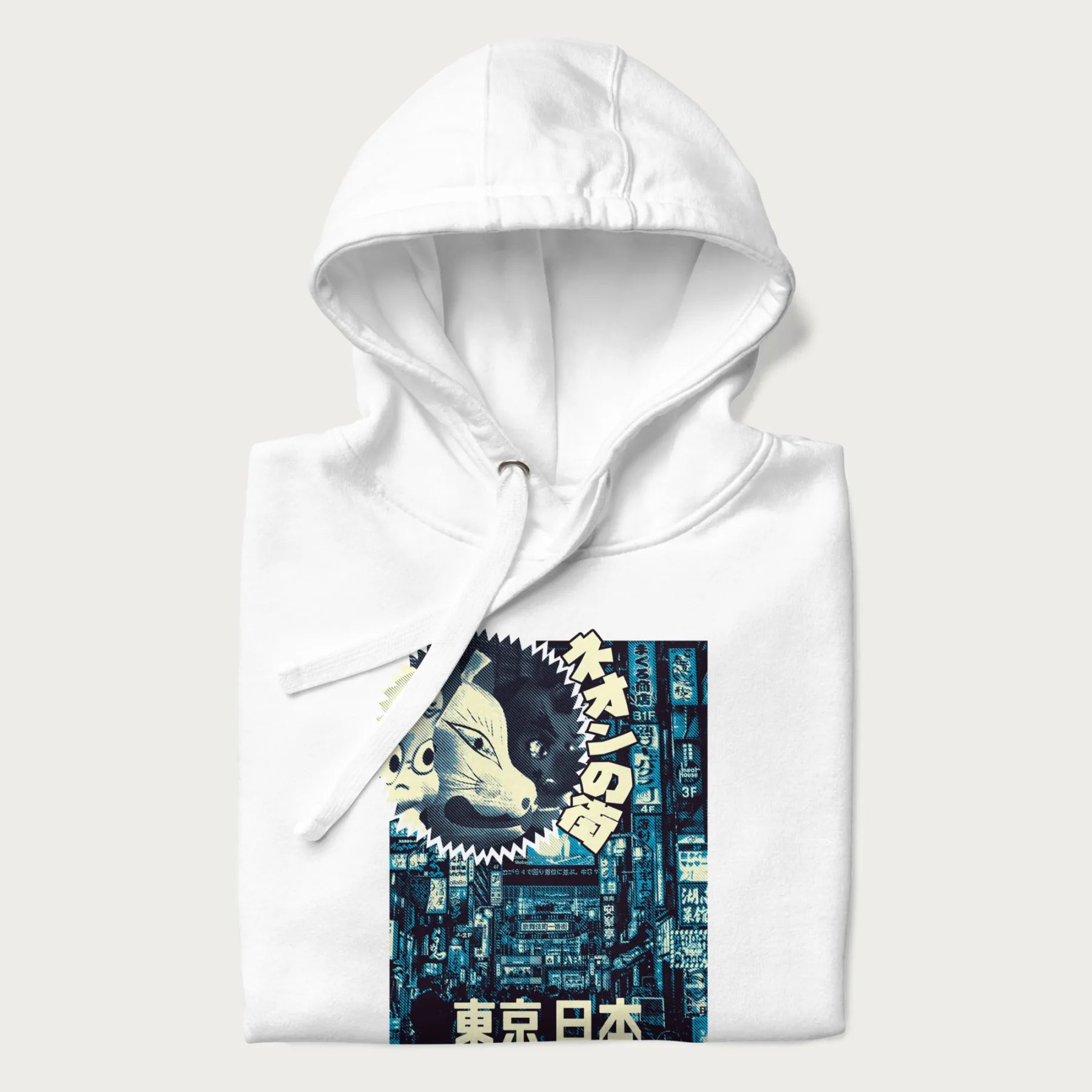 Folded white hoodie with Japanese text '東京日本' translating to 'Tokyo, Japan', with three traditional Japanese masks over a neon-lit Tokyo background.