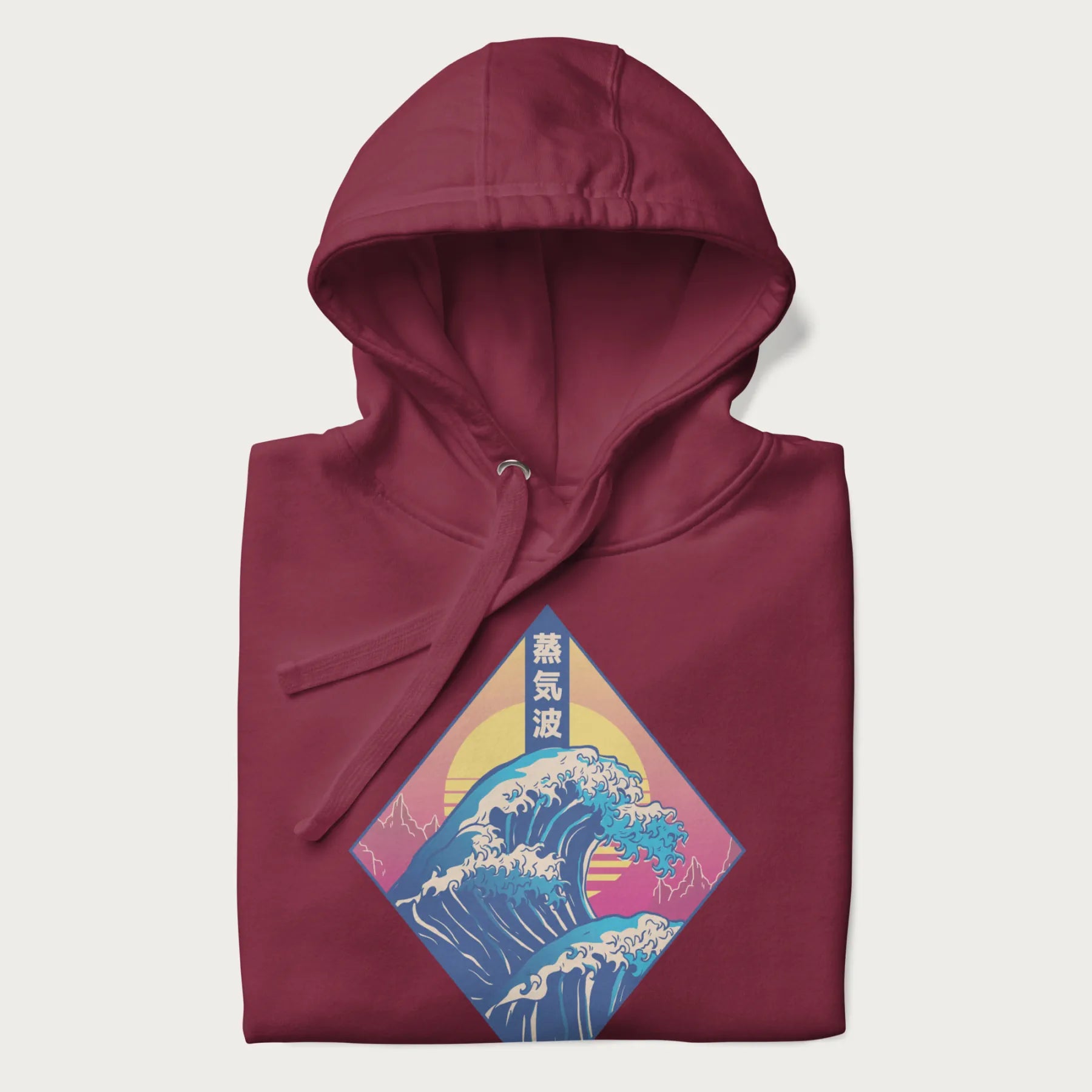 Folded maroon hoodie with Japanese 'Great Wave' graphic print in vaporwave style, rendered in bright, psychedelic colors in diamond-shaped layout.