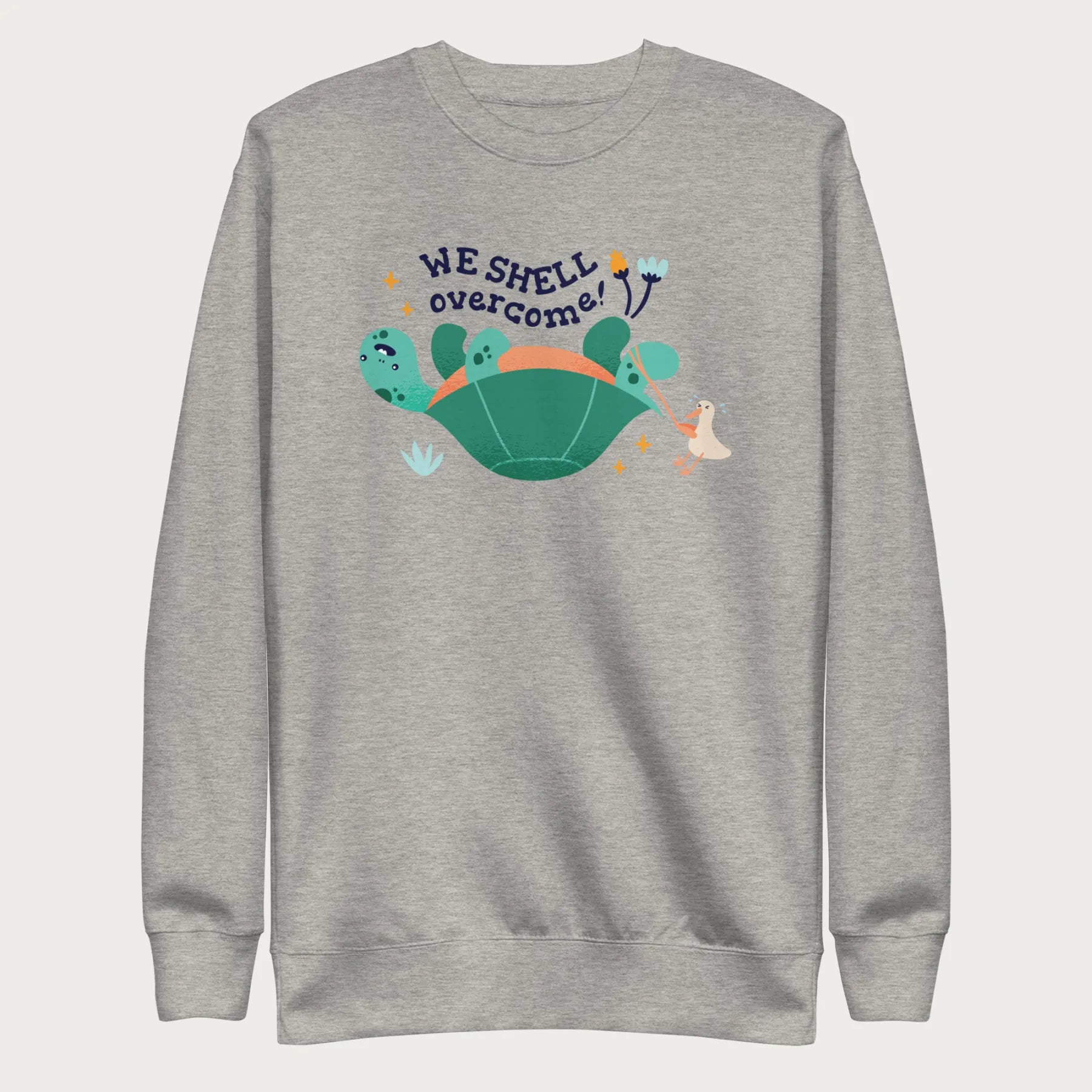 Light grey sweatshirt with a graphic of a turtle flipped on it's shell with the phrase 'We Shell Overcome.'