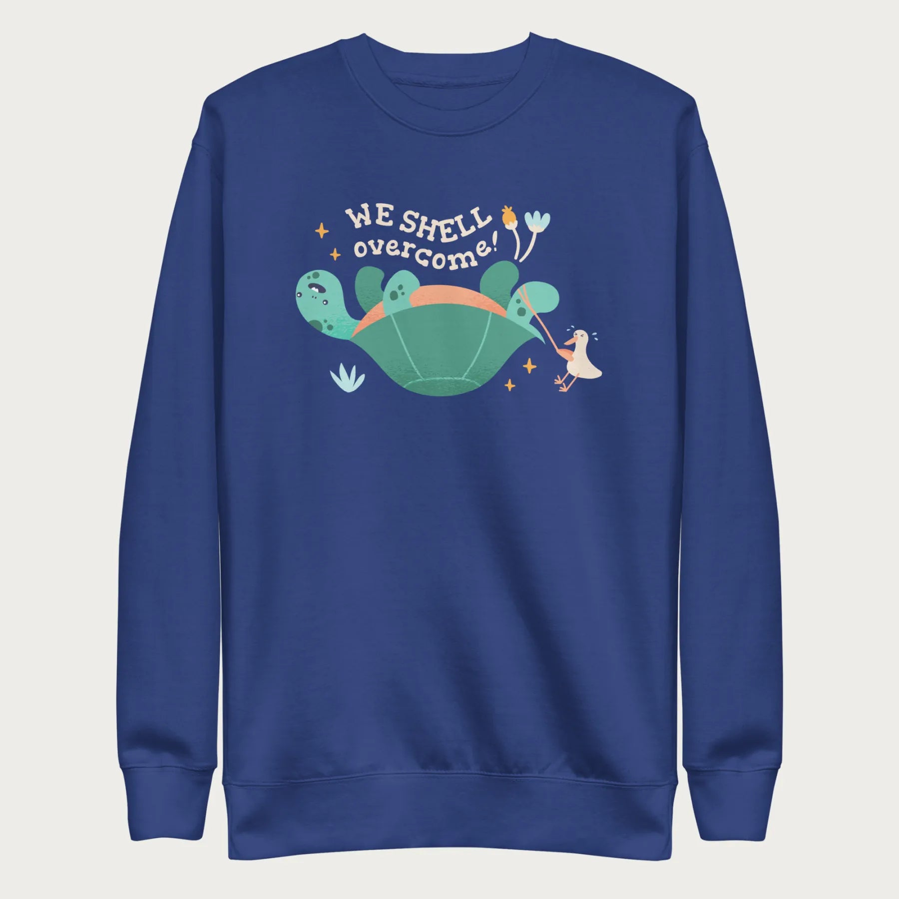 Royal blue sweatshirt with a graphic of a turtle flipped on it's shell with the phrase 'We Shell Overcome.'