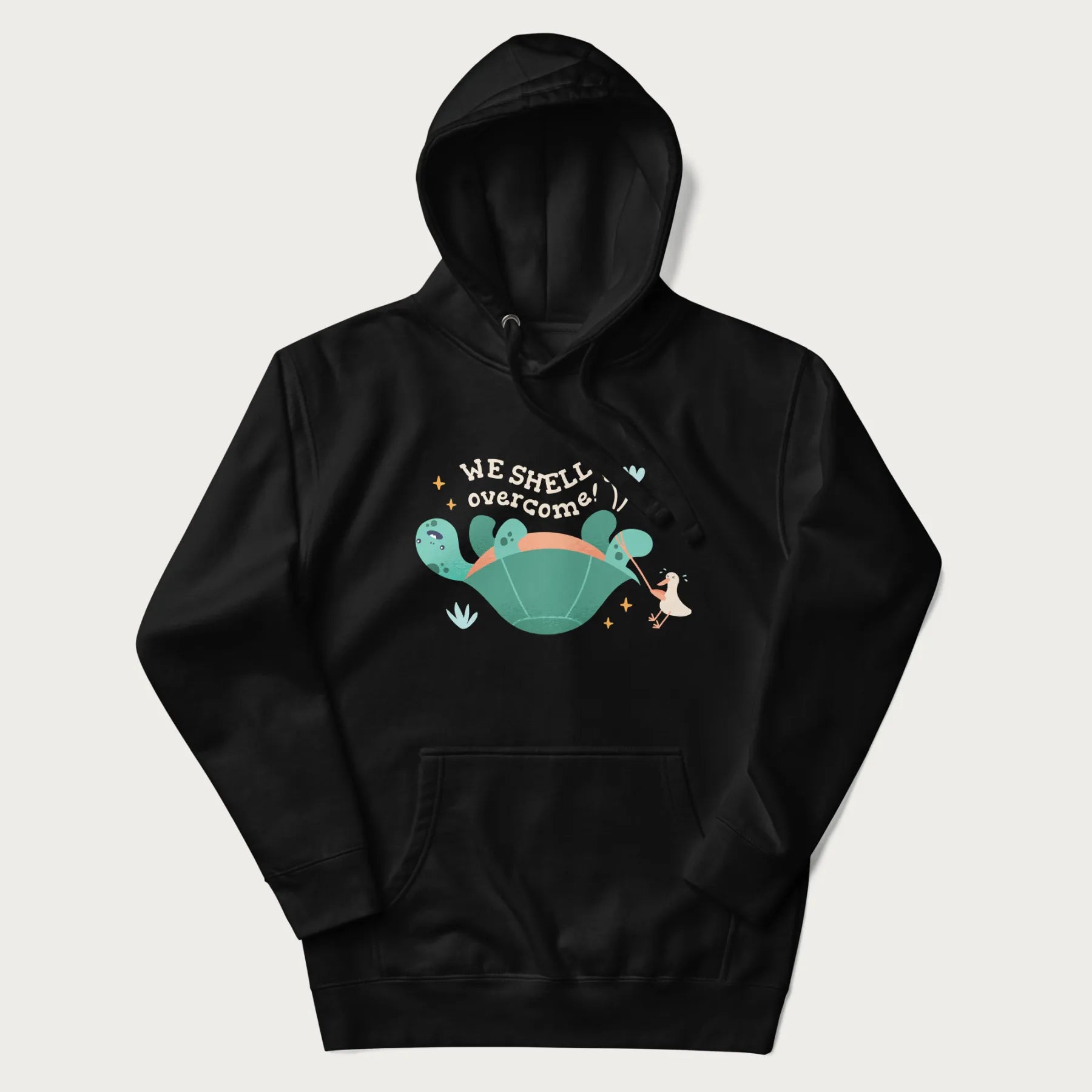 Black hoodie with graphic of a turtle and a duck with the text 'We Shell Overcome'.
