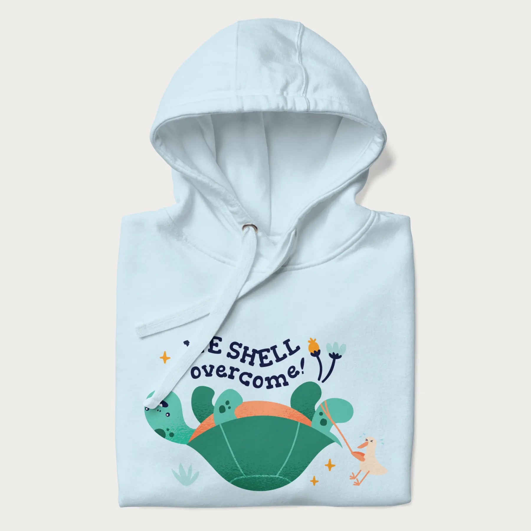 Folded light blue hoodie with graphic of a turtle and a duck with the text 'We Shell Overcome'.