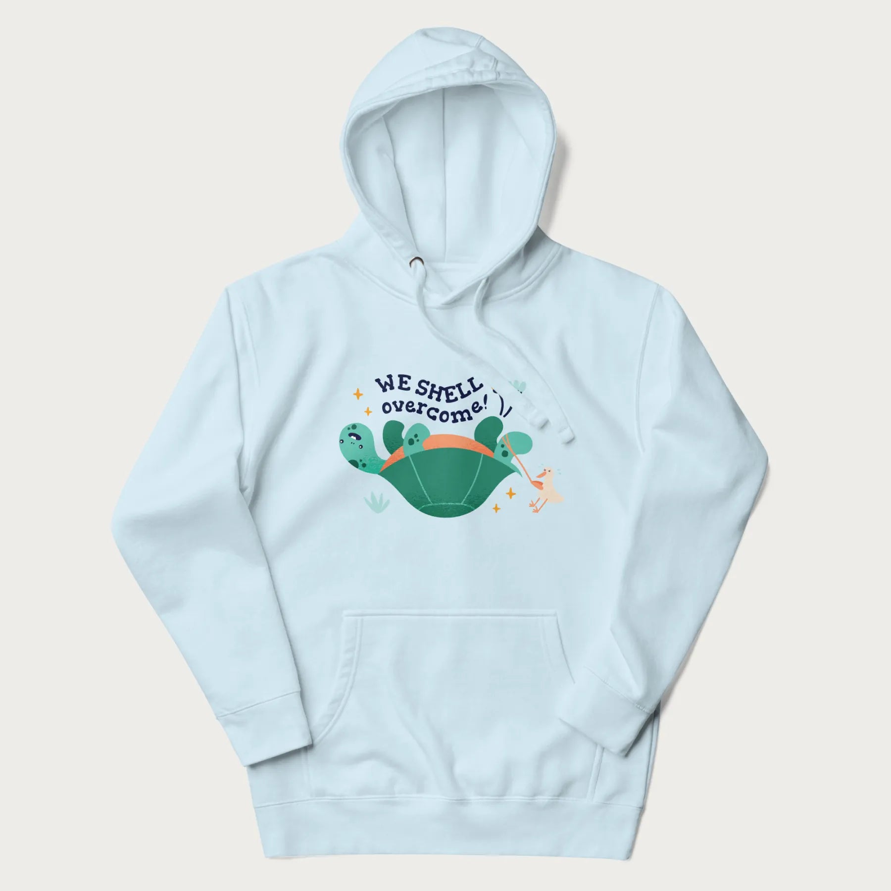 Light blue hoodie with graphic of a turtle and a duck with the text 'We Shell Overcome'.