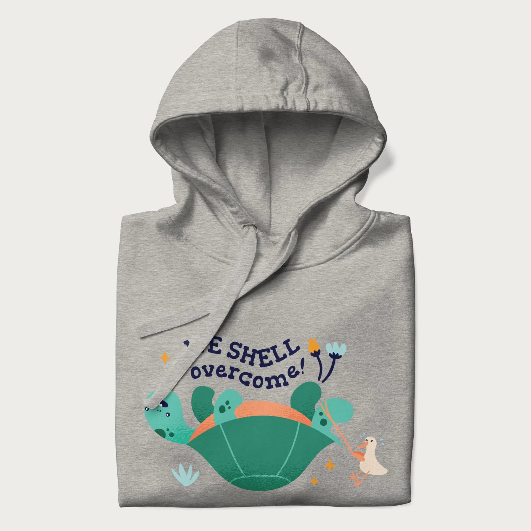 Folded light grey hoodie with graphic of a turtle and a duck with the text 'We Shell Overcome'.