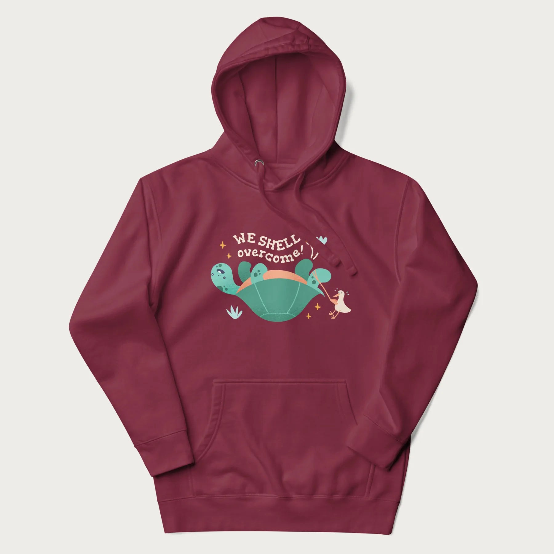 Maroon hoodie with graphic of a turtle and a duck with the text 'We Shell Overcome'.