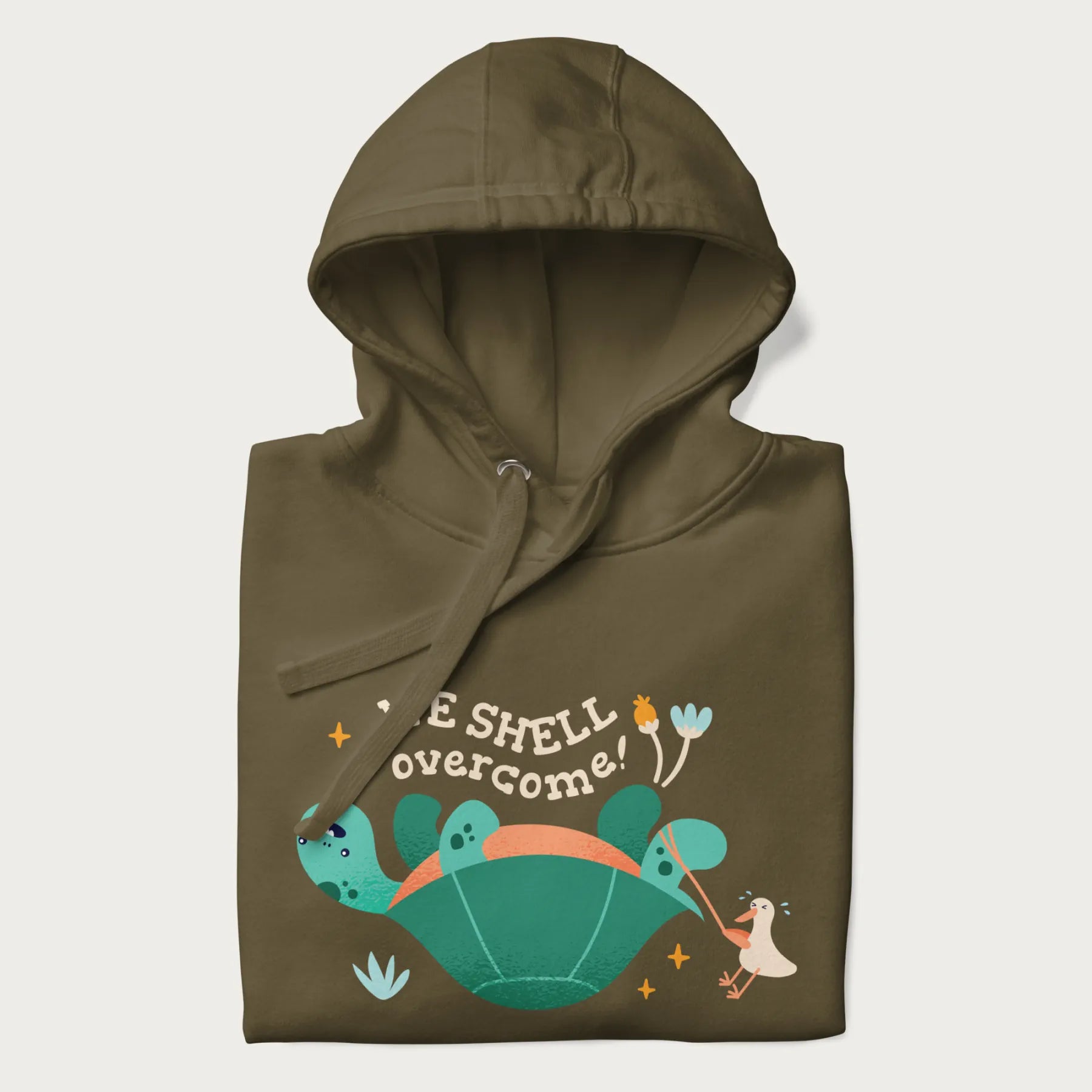 Folded military green hoodie with graphic of a turtle and a duck with the text 'We Shell Overcome'.