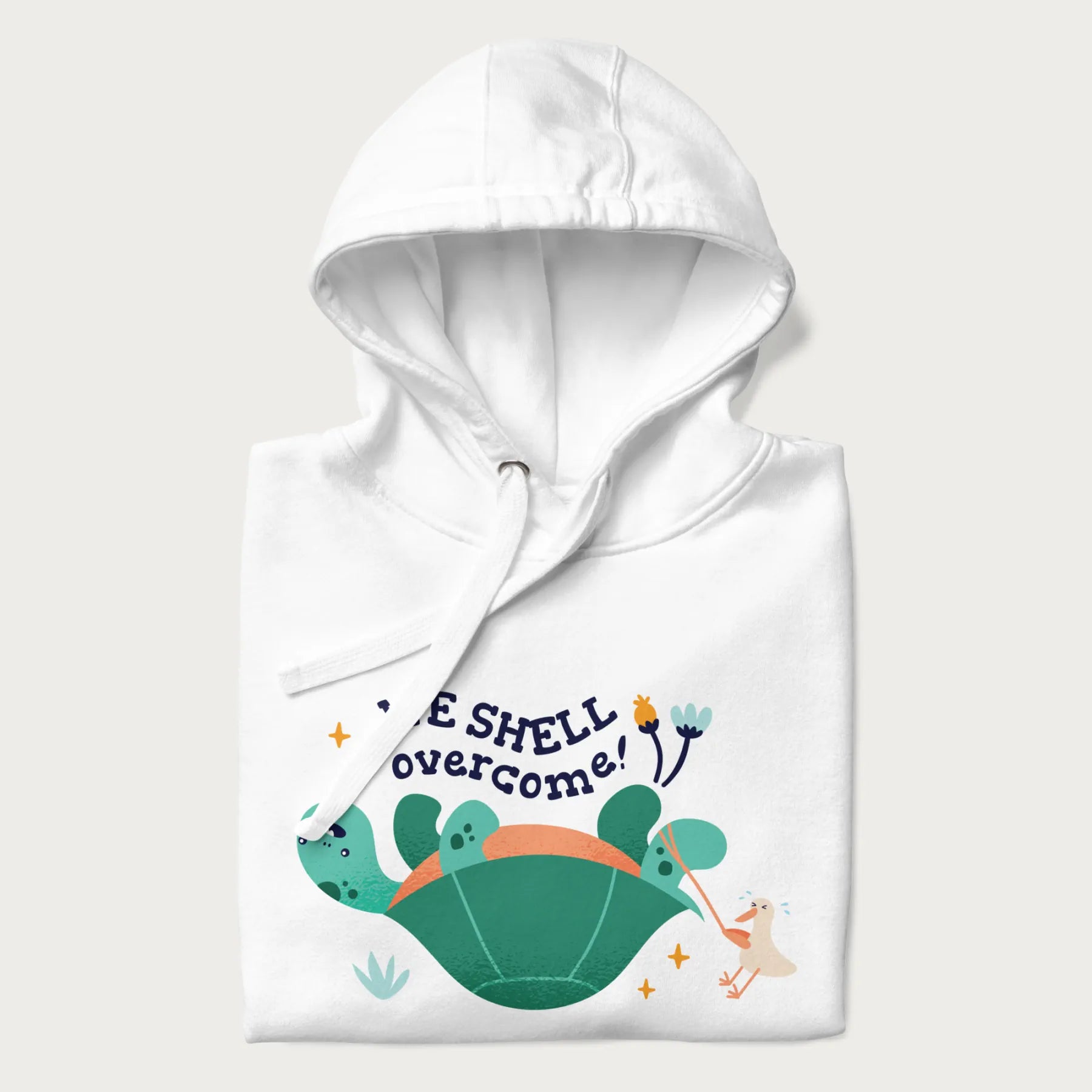 Folded white hoodie with graphic of a turtle and a duck with the text 'We Shell Overcome'.