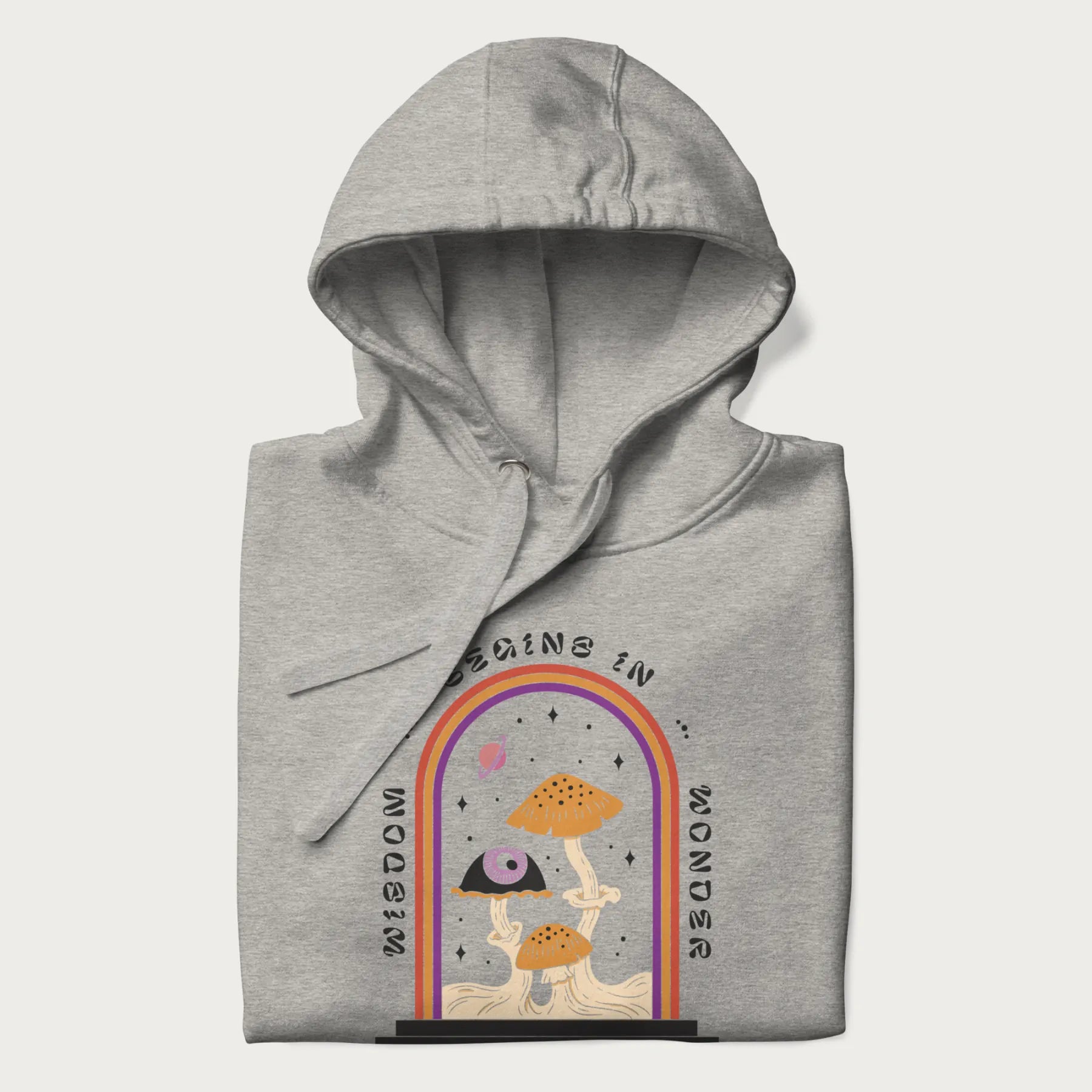 Folded light grey hoodie with graphic of mystical mushrooms with an all-seeing eye and the text 'Wisdom Begins in Wonder' framed by a rainbow arch.