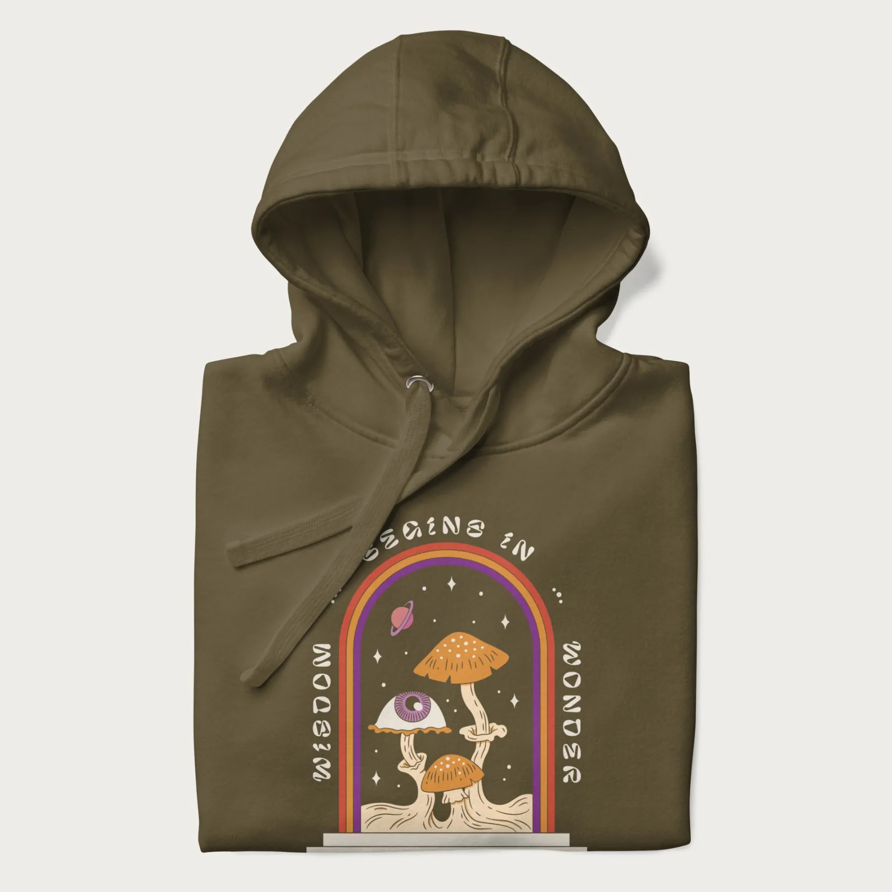 Folded military green hoodie with graphic of mystical mushrooms with an all-seeing eye and the text 'Wisdom Begins in Wonder' framed by a rainbow arch.