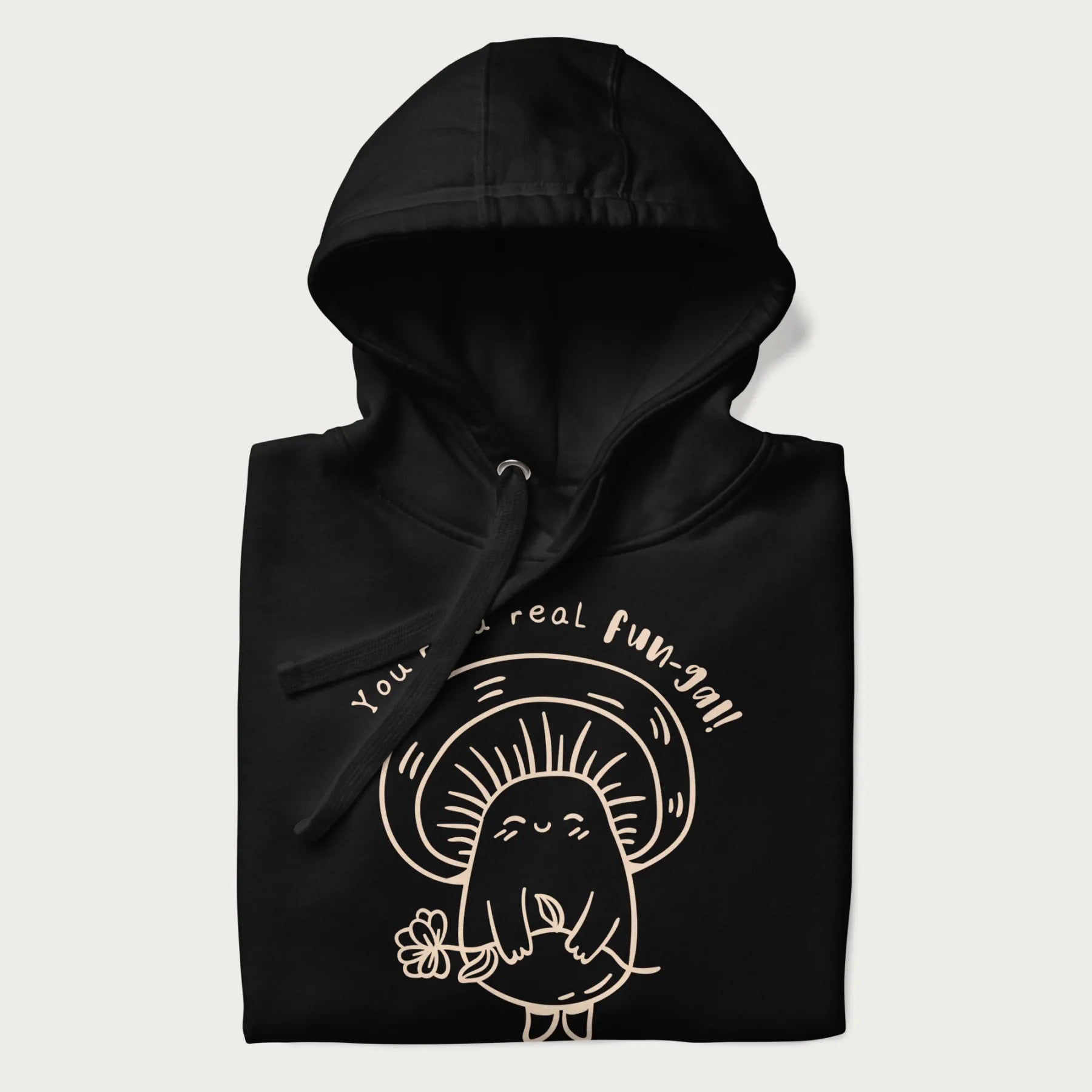 Folded black hoodie with graphic of a cute mushroom holding a flower and the text "You're a Real Fun-gal!"