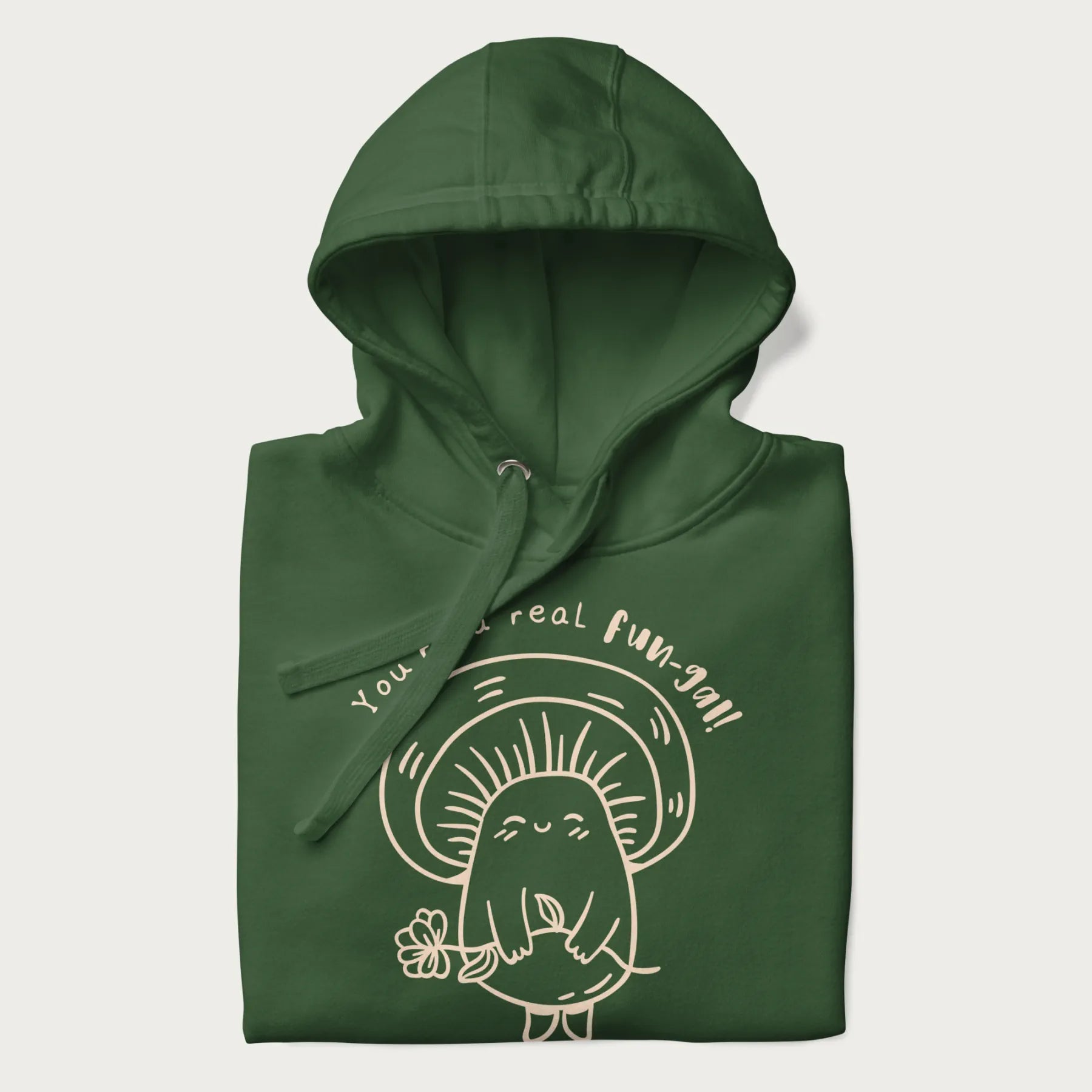 Folded forest green hoodie with graphic of a cute mushroom holding a flower and the text "You're a Real Fun-gal!"