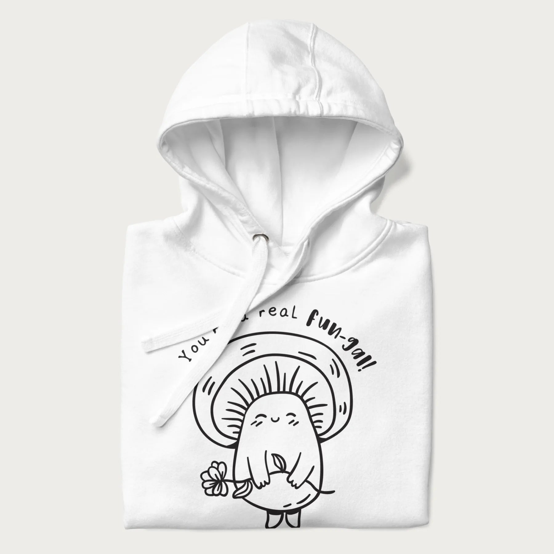 Folded white hoodie with graphic of a cute mushroom holding a flower and the text "You're a Real Fun-gal!"