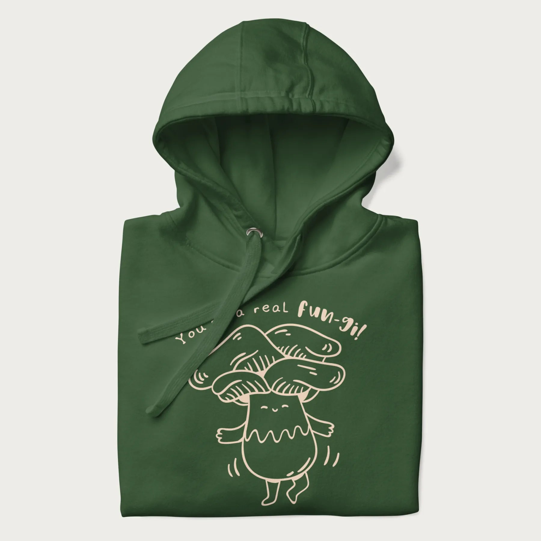 Folded forest green hoodie with graphic of a cute mushroom joyfully dancing with the text "You're a Real Fun-gi!"