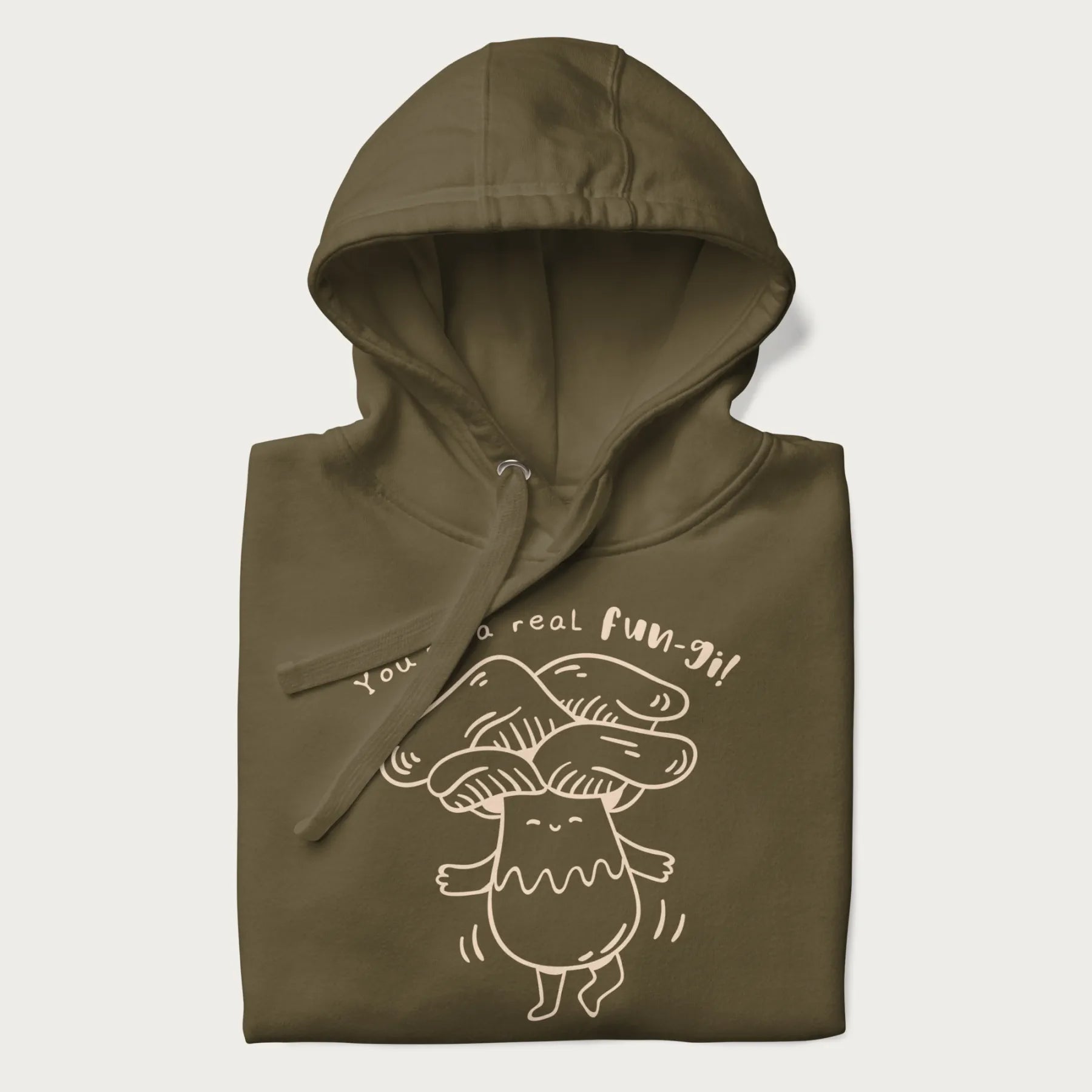 Folded military green hoodie with graphic of a cute mushroom joyfully dancing with the text "You're a Real Fun-gi!"
