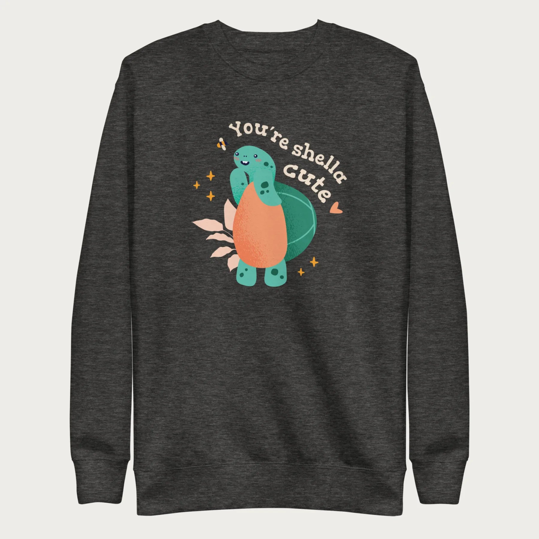 Dark grey sweatshirt with a cute graphic of a smiling turtle and bee with the phrase 'You're Shella Cute.'