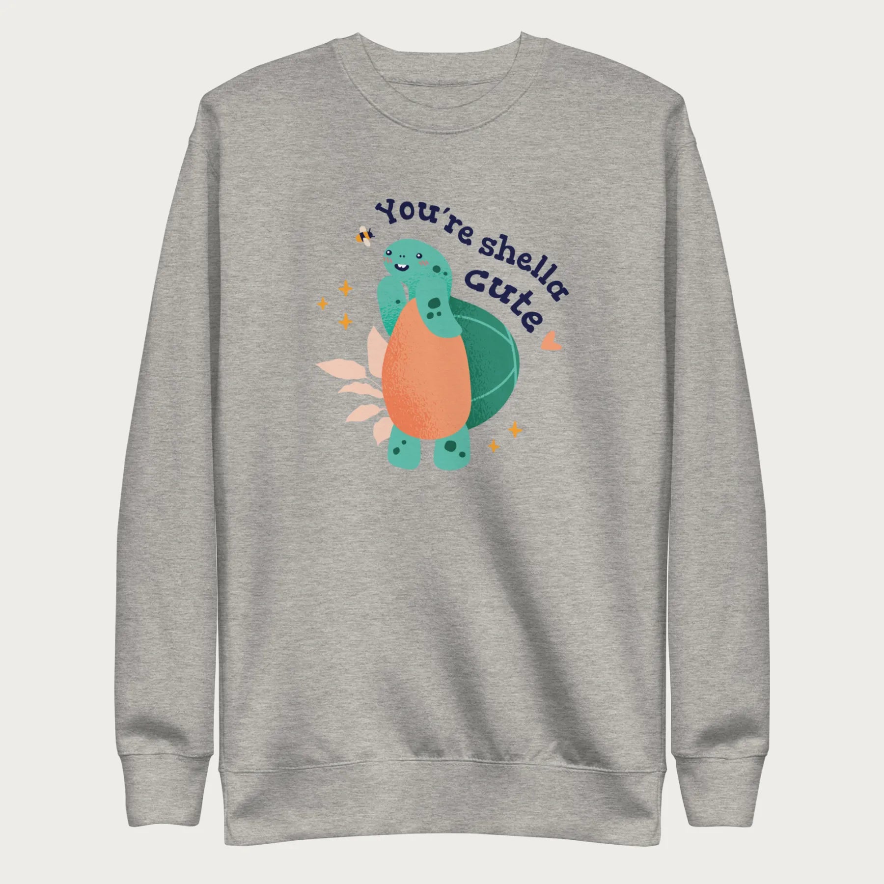 Light grey sweatshirt with a cute graphic of a smiling turtle and bee with the phrase 'You're Shella Cute.'