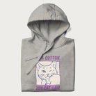 Folded light grey hoodie with graphic of a winking cat with the text "80% cotton 20% cat hair".