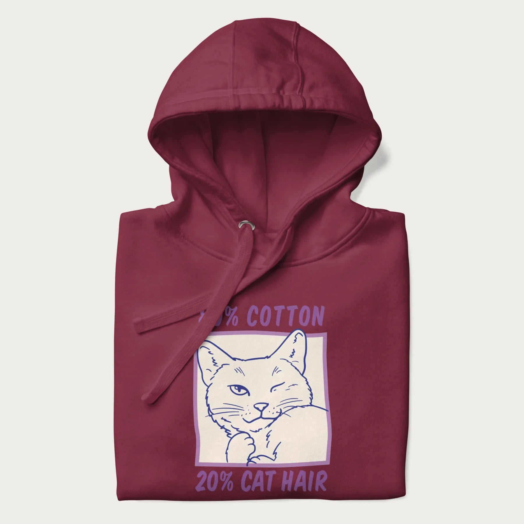 Folded maroon hoodie with graphic of a winking cat with the text "80% cotton 20% cat hair".
