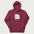 Maroon hoodie with graphic of a winking cat with the text "80% cotton 20% cat hair".
