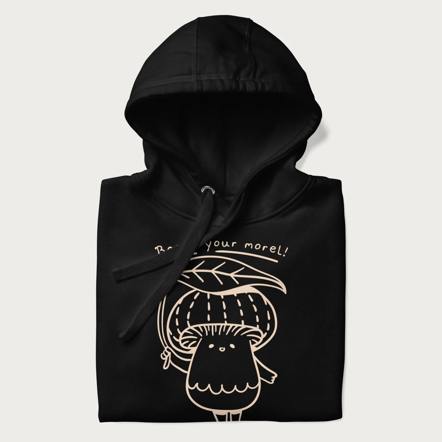 Folded black hoodie with graphic of a cute mushroom holding a leaf with the text "Boost Your Morel."