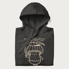 Folded dark grey hoodie with graphic of a cute mushroom holding a leaf with the text "Boost Your Morel."