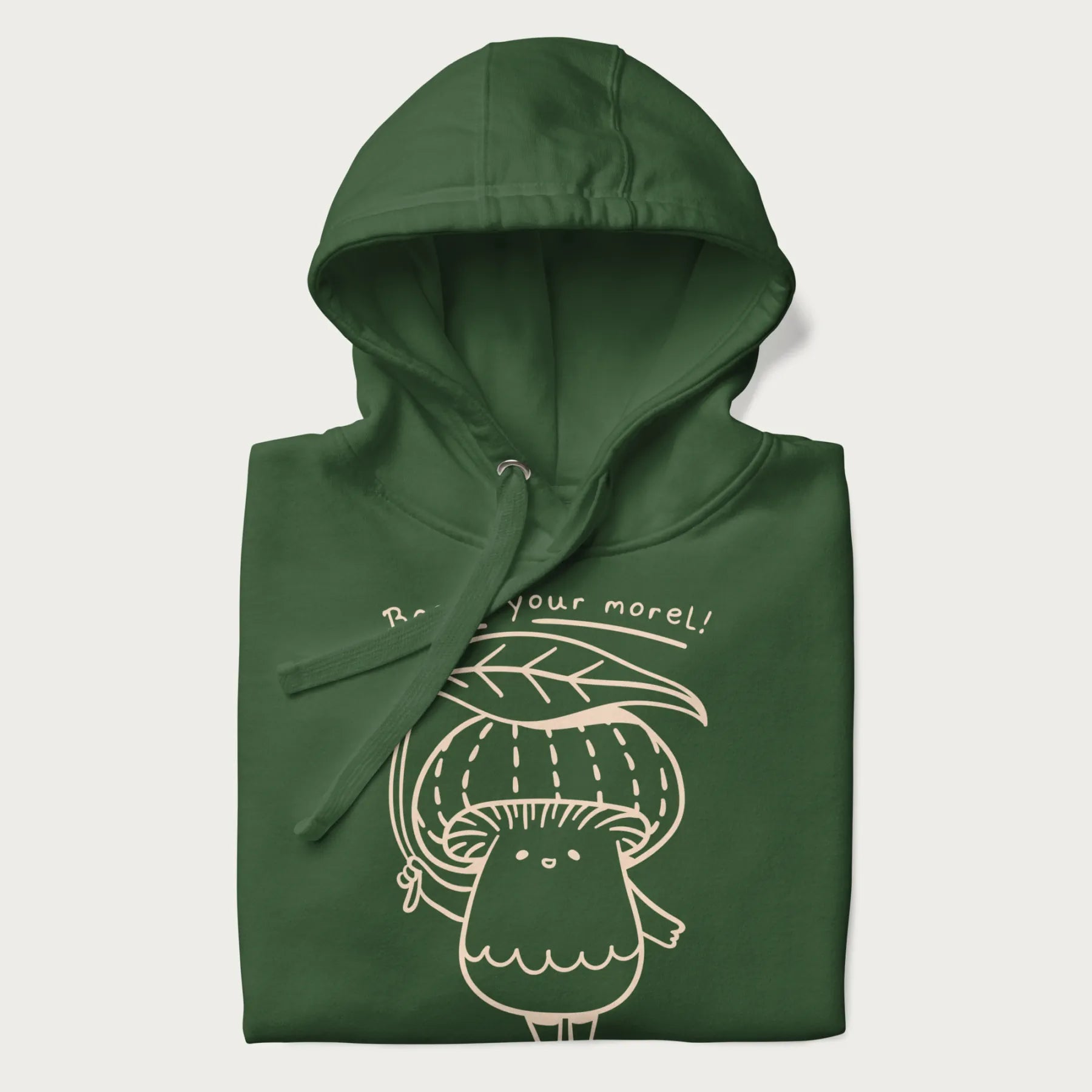 Folded forest green hoodie with graphic of a cute mushroom holding a leaf with the text "Boost Your Morel."