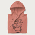 Folded light pink hoodie with graphic of a cute mushroom holding a leaf with the text "Boost Your Morel."