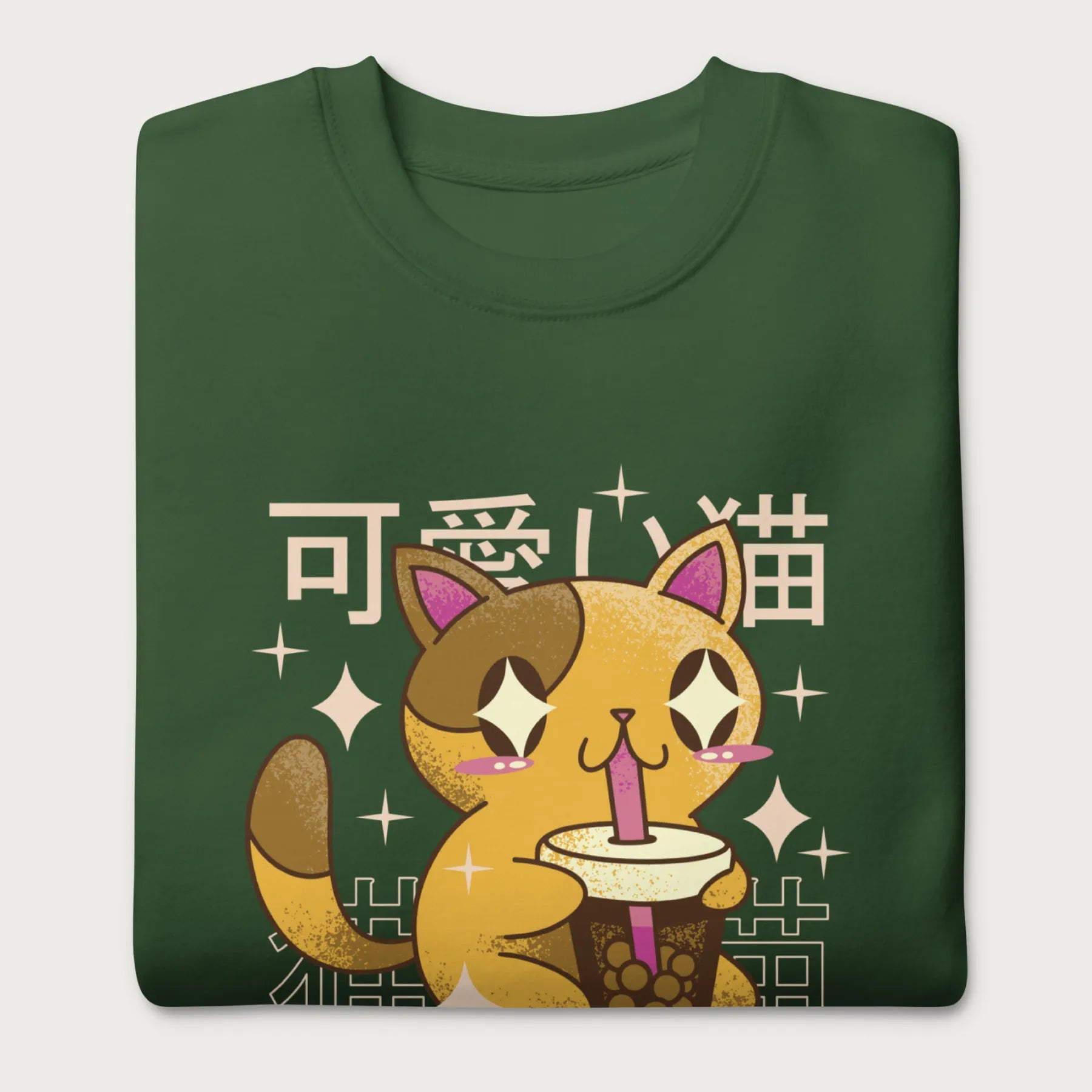 Folded forest green sweatshirt with Japanese text and a kawaii graphic of a cat drinking bubble tea.