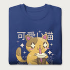 Folded royal blue sweatshirt with Japanese text and a kawaii graphic of a cat drinking bubble tea.