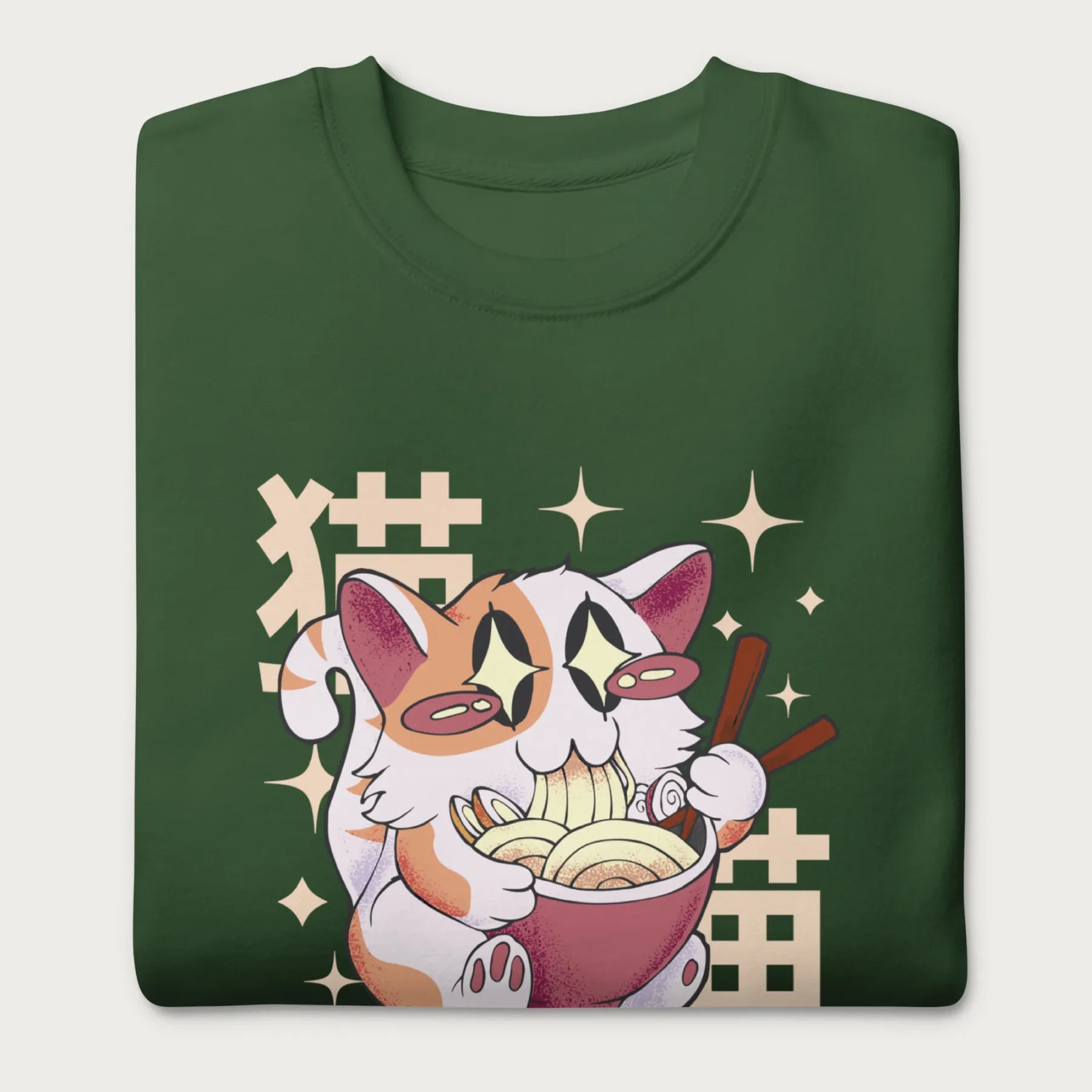 Folded forest green sweatshirt with Japanese text and a graphic of a kawaii cat eating ramen.