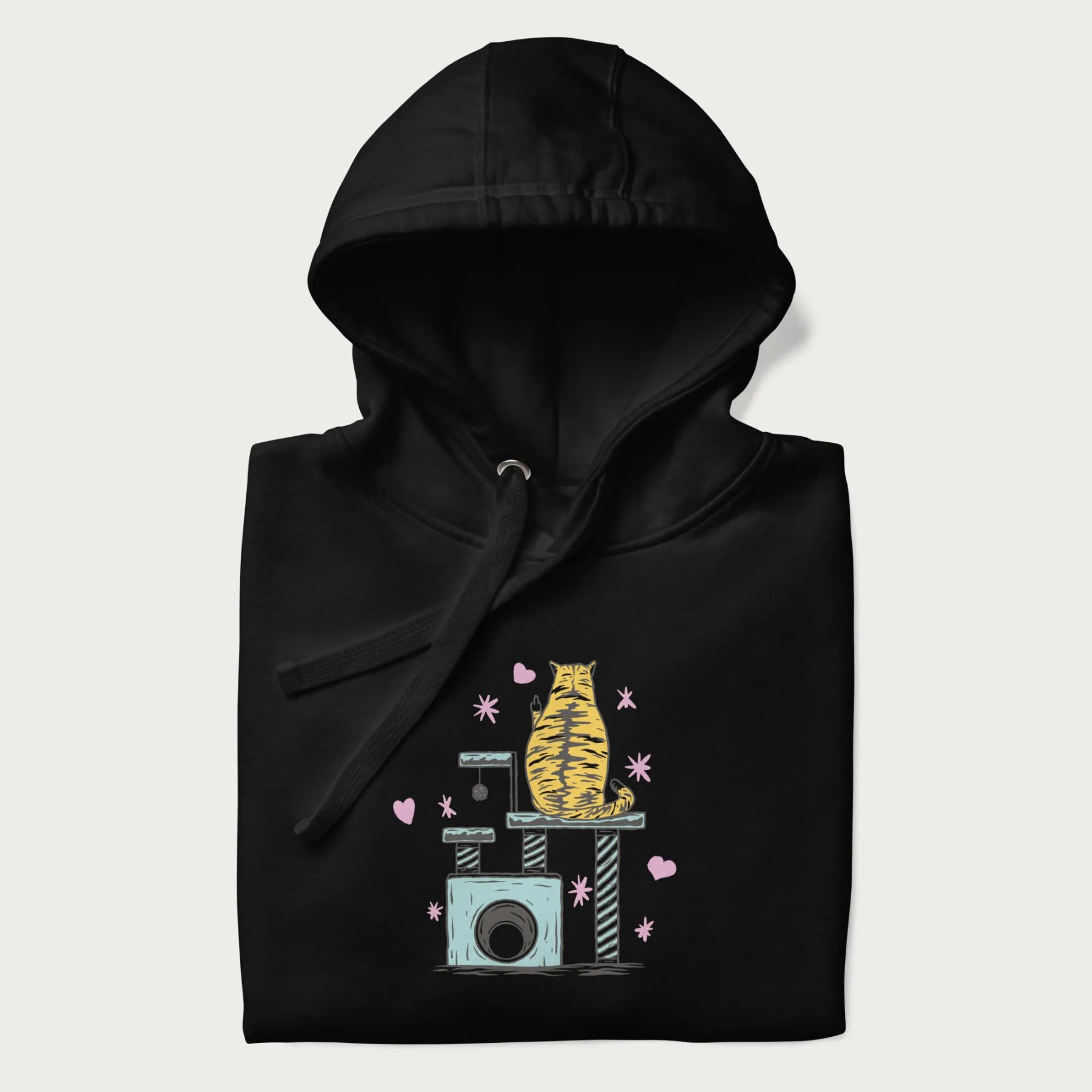 Folded black hoodie with graphic of a tabby cat on a scratching post, raising its middle finger.